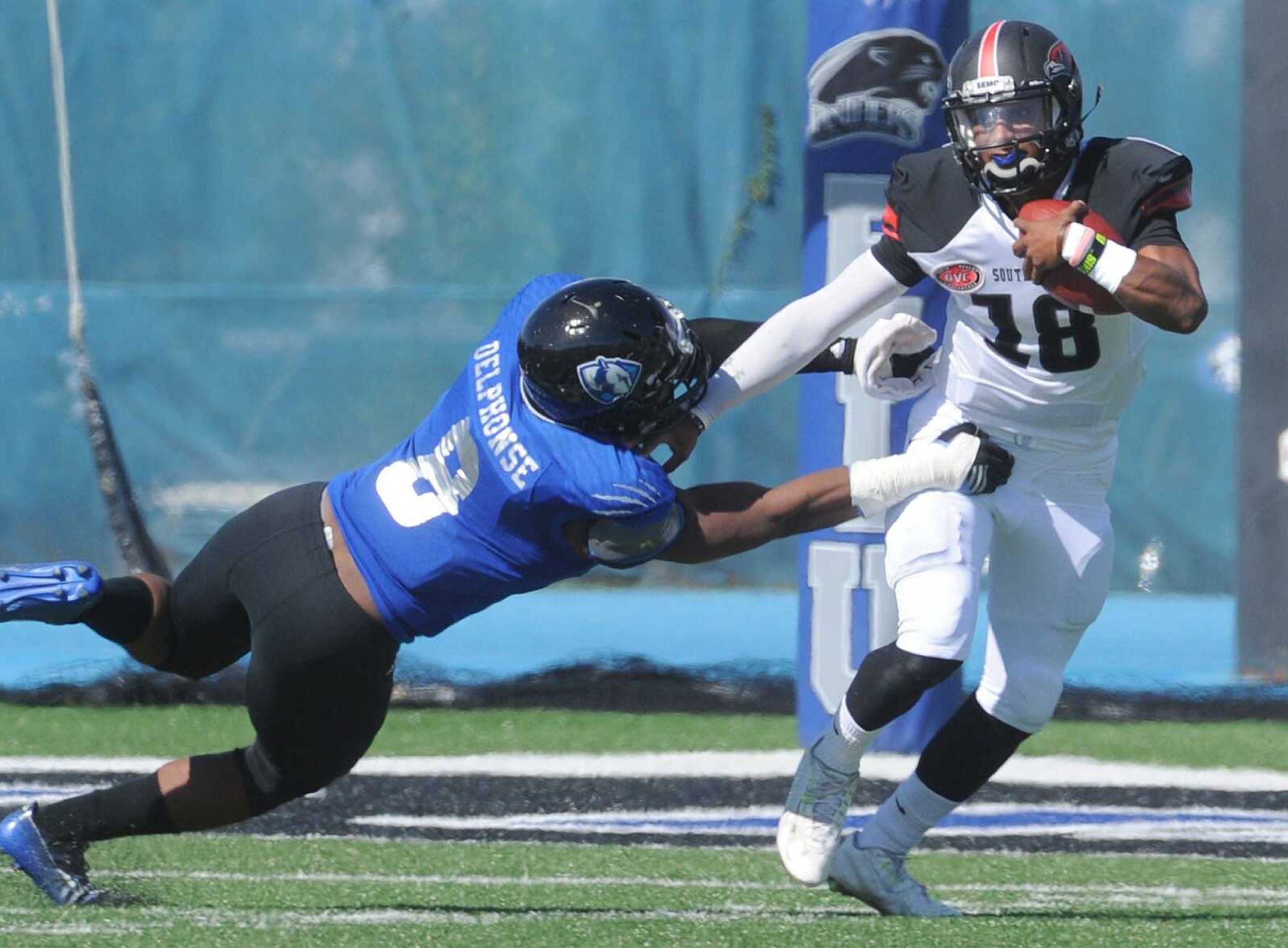 Southeast Missouri State quarterback Dante Vandeven is pressured by Eastern Illinois  Fedney Delphonse during the second quarter Saturday, Oct. 10, 2015 in Charleston, Illinois. (Fred Lynch)