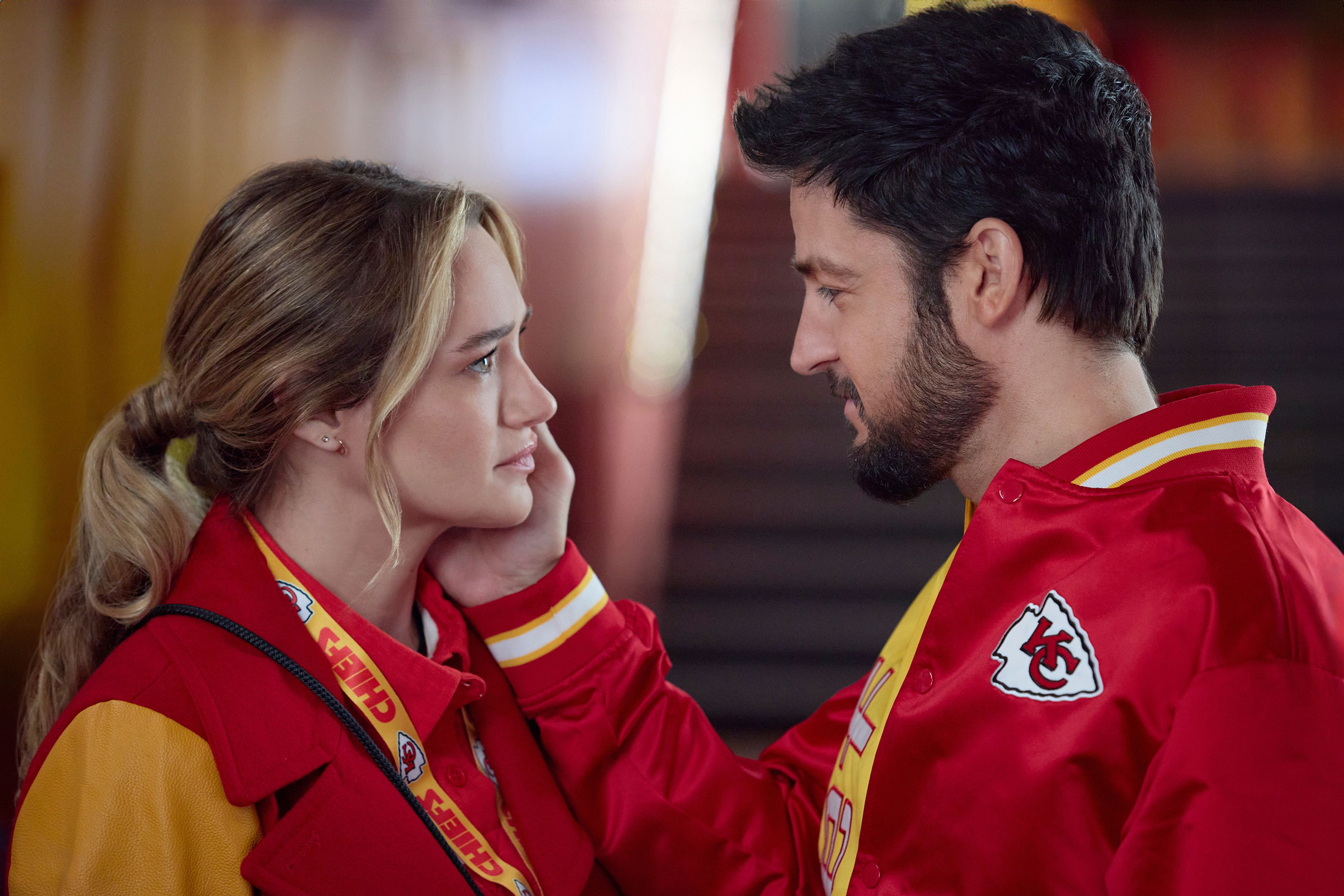 This image released by Hallmark Media shows Hunter King, left, and Tyler Hynes in a scene from "Holiday Touchdown: A Chiefs Love Story. (Joshua Haines/Hallmark Media via AP)