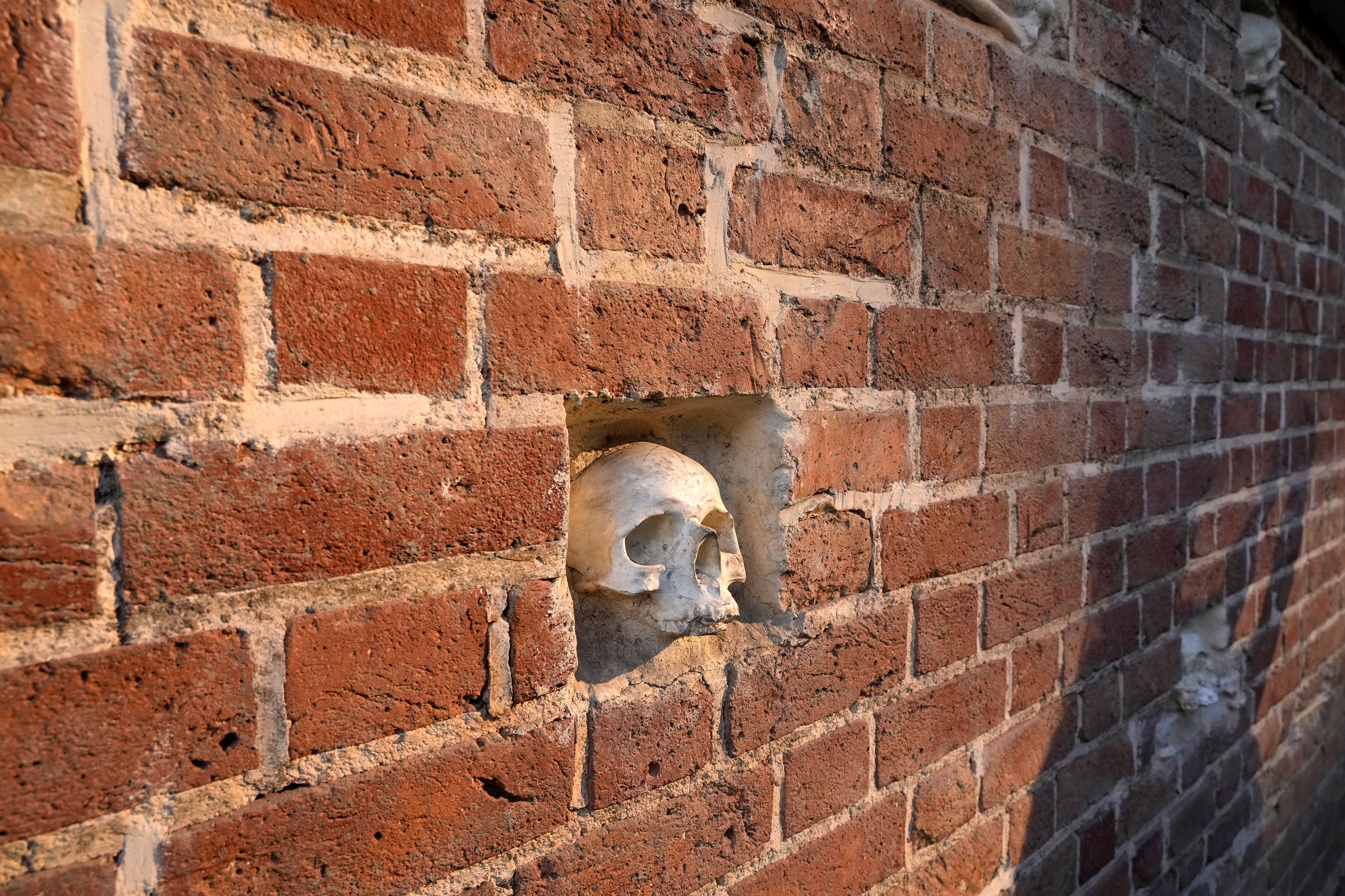 Artificial skulls and bones are placed into the exterior wall of the former U.S. Embassy, which has been turned into an anti-American museum, in Tehran, Iran, Tuesday, Oct. 22, 2024. (AP Photo/Vahid Salemi)