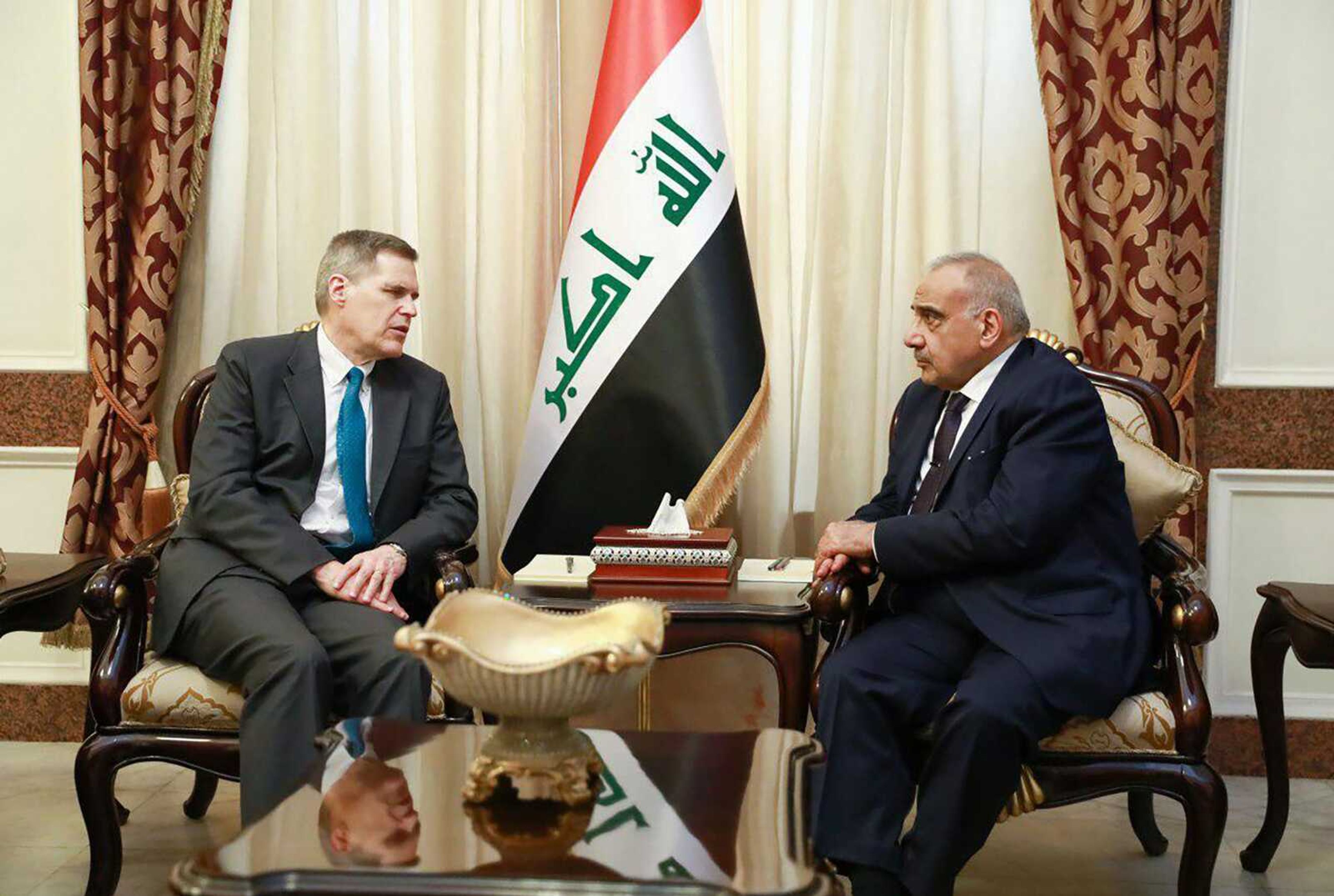 A photo released by the Iraqi Prime Minister Media Office, shows Iraqi acting Prime Minister Adil Abdul-Mahdi, right, meeting with U.S. Ambassador to Iraq Matthew Tueller at the prime minister's office, in Baghdad, Iraq, Monday, Jan. 6, 2020. (Iraqi Prime Minister Media Office, via AP)