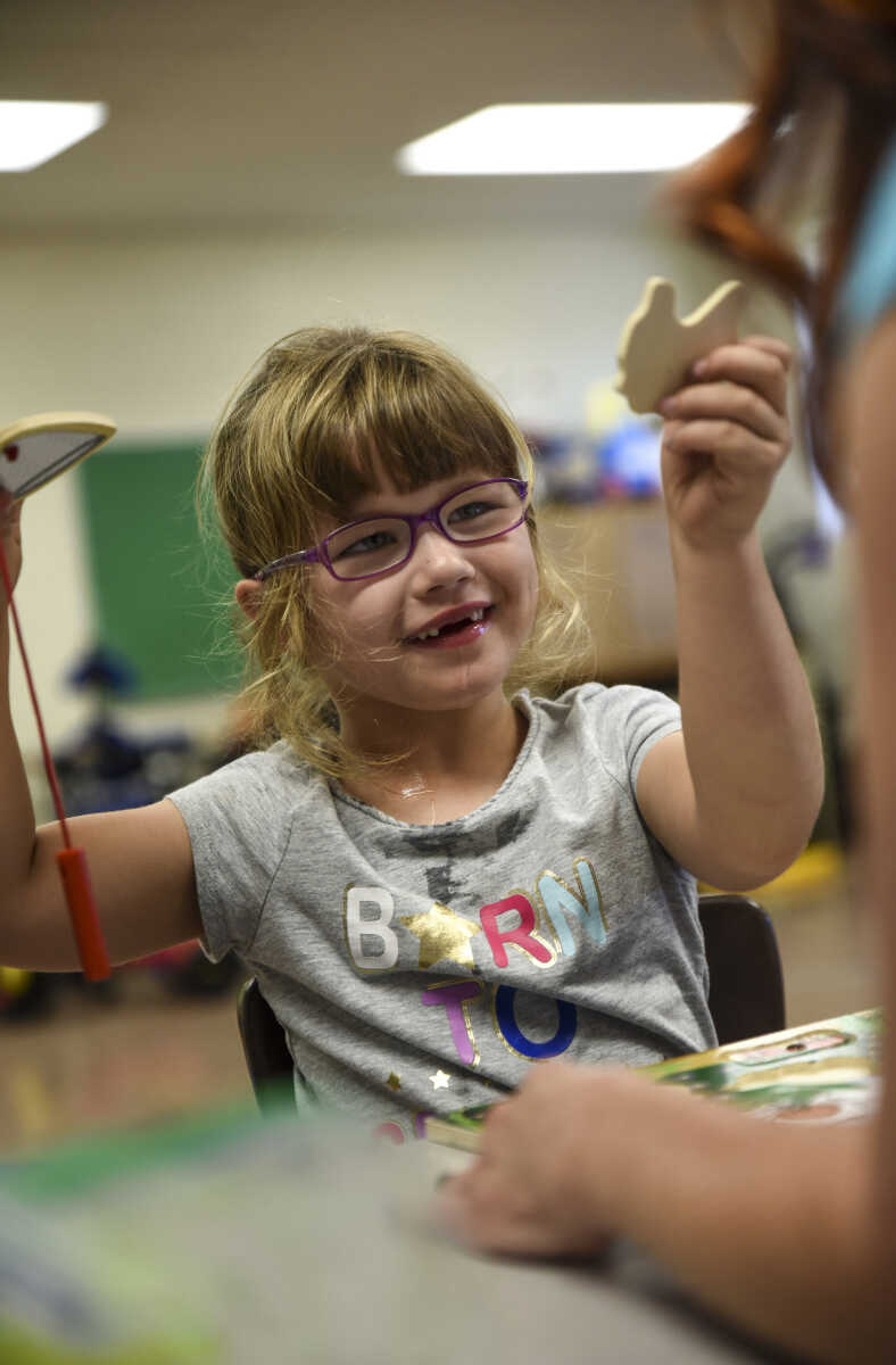 Lindyn Davenport, 6, holds up a puzzle piece to show Teresa Cobb, occupational therapist for Woodland school district, as part of her special services provided at Woodland Elementary School Tuesday, June 5, 2018 in Marble Hill.