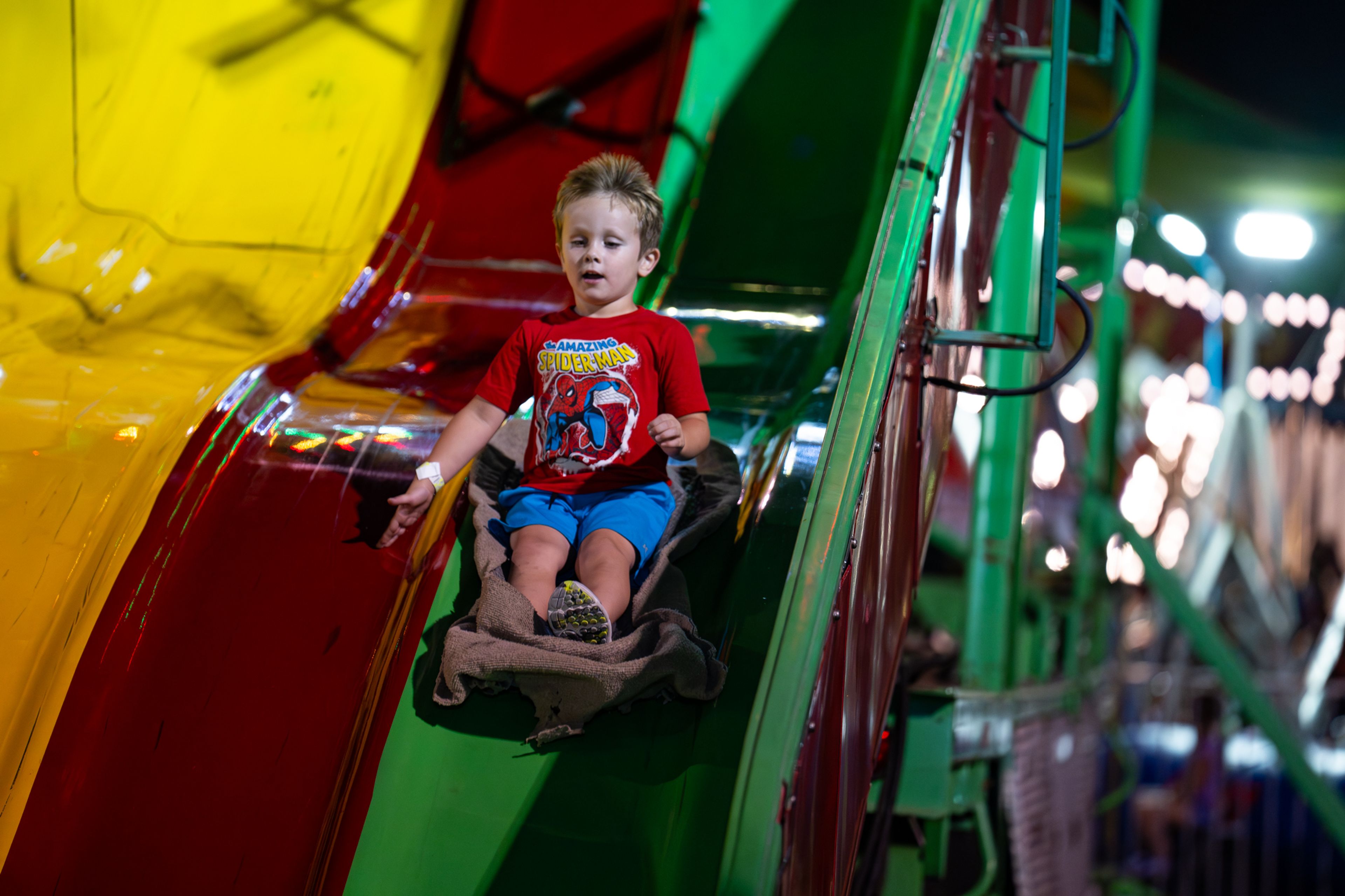 Maxwell Gramlisch rides down the slide on a sack while his parents cheer him on Wednesday, Sept. 11, at the SEMO District Fair in Cape Girardeau.