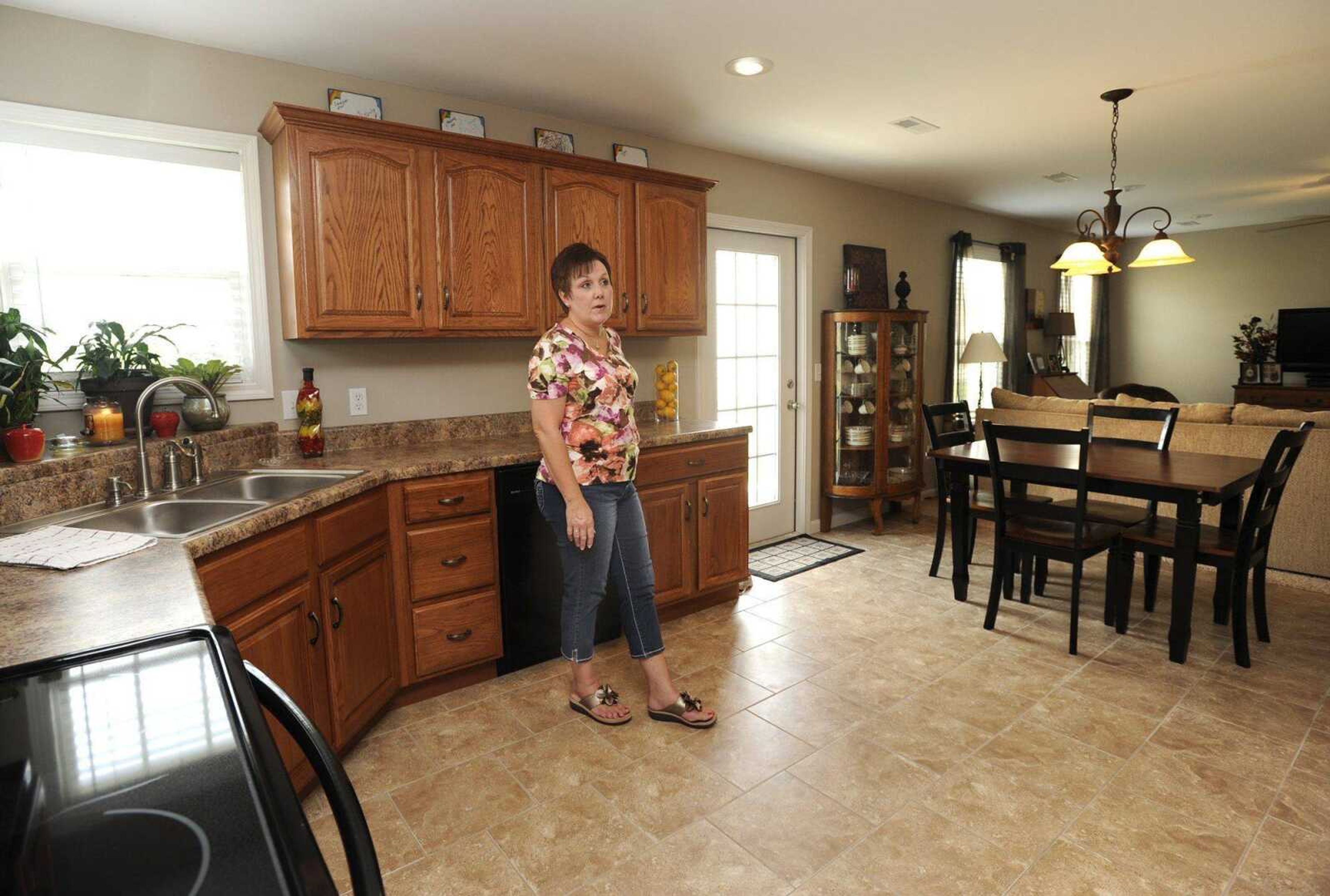 Lisa Goodwin shows Saturday the new home in which she has lived for about a month in the Jackson Ridge subdivision. (Fred Lynch)