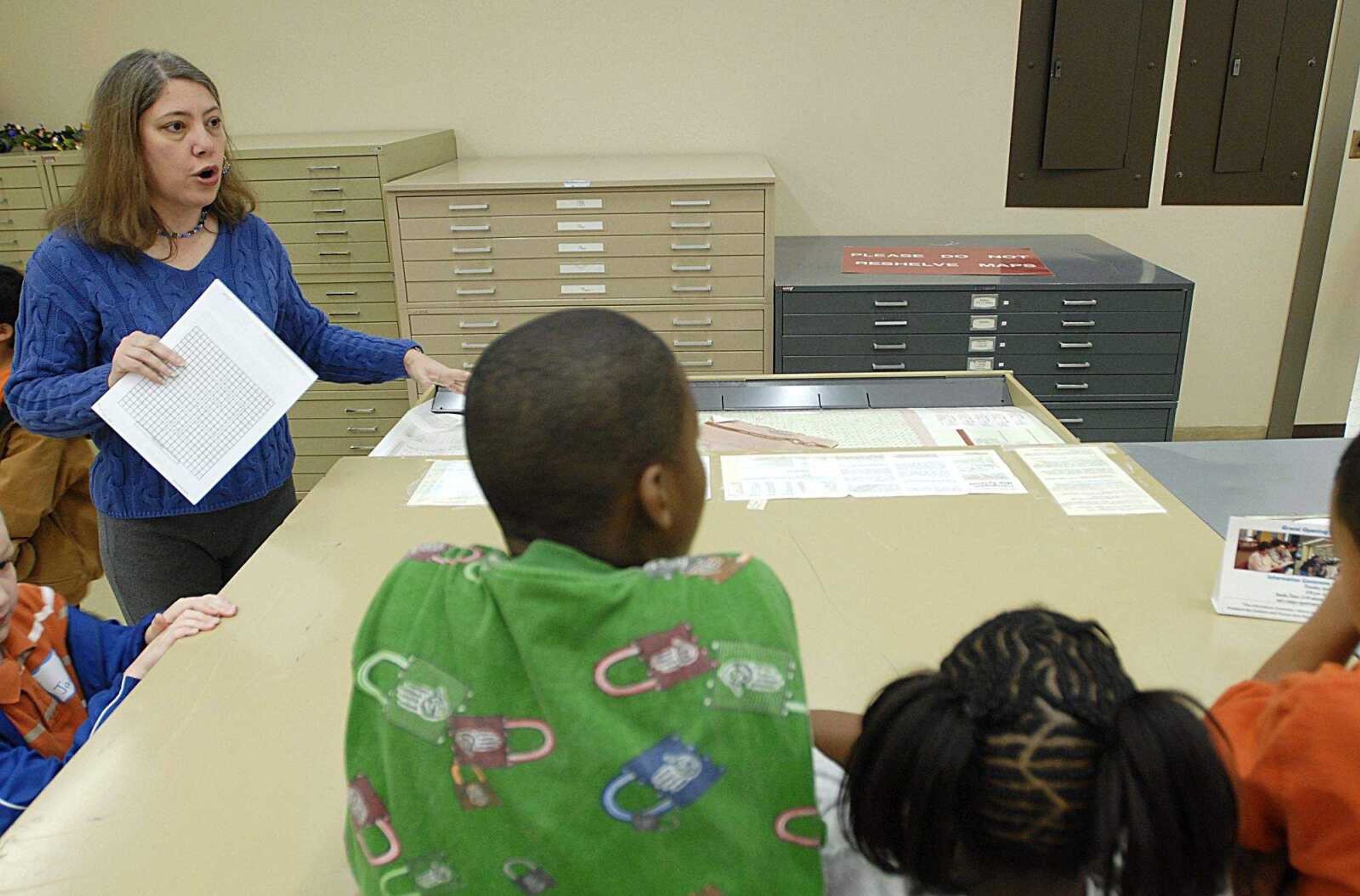 AARON EISENHAUER ~ aeisenhauer@semissourian.com
Library associate Twylla James shows students some of the reference materials in Kent Library.