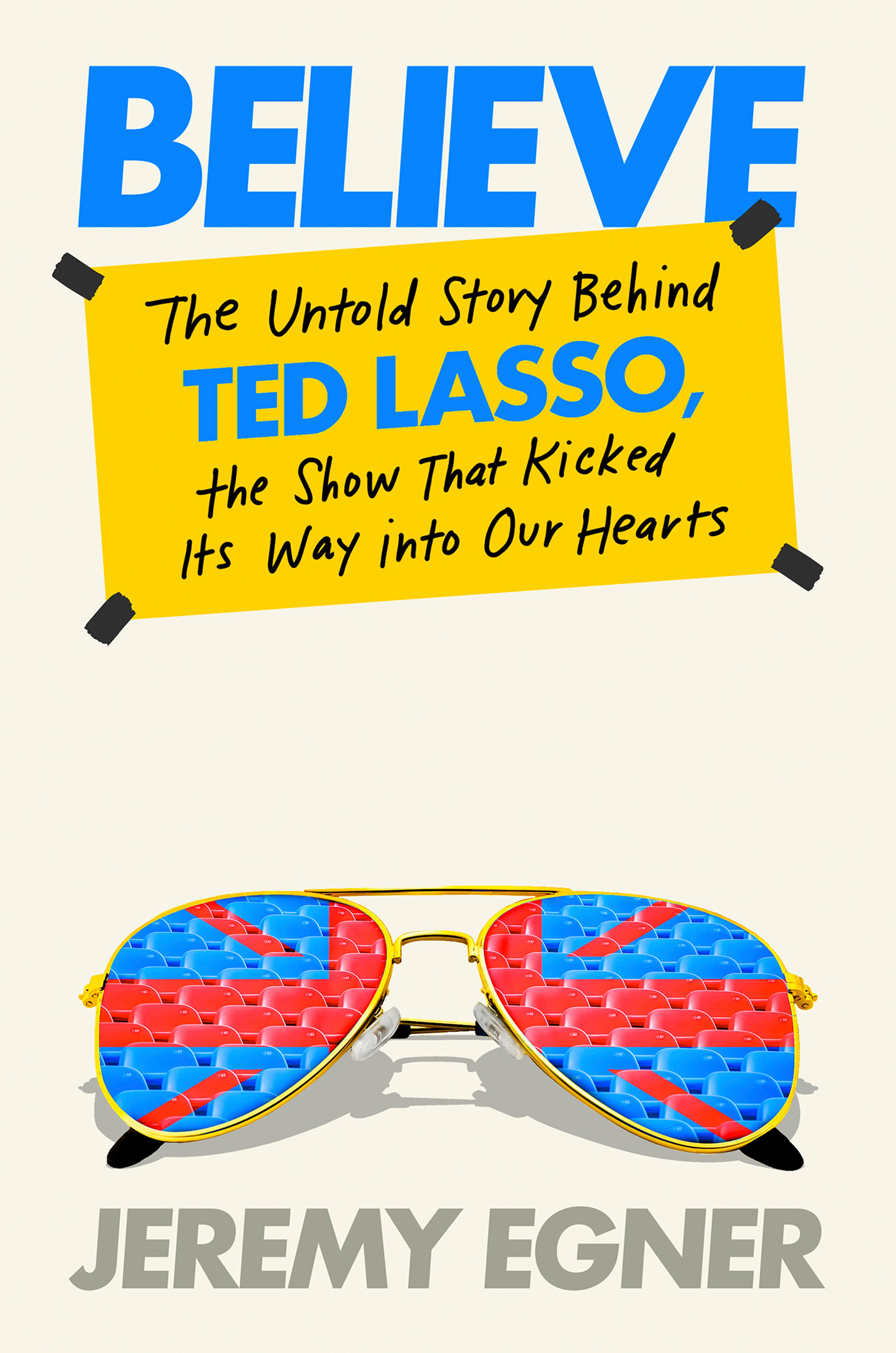 This cover image released by Dutton shows "Believe: The Untold Story Behind Ted Lasso, the Show That Kicked Its Way Into Our Hearts" by Jeremy Egner. (Dutton via AP)