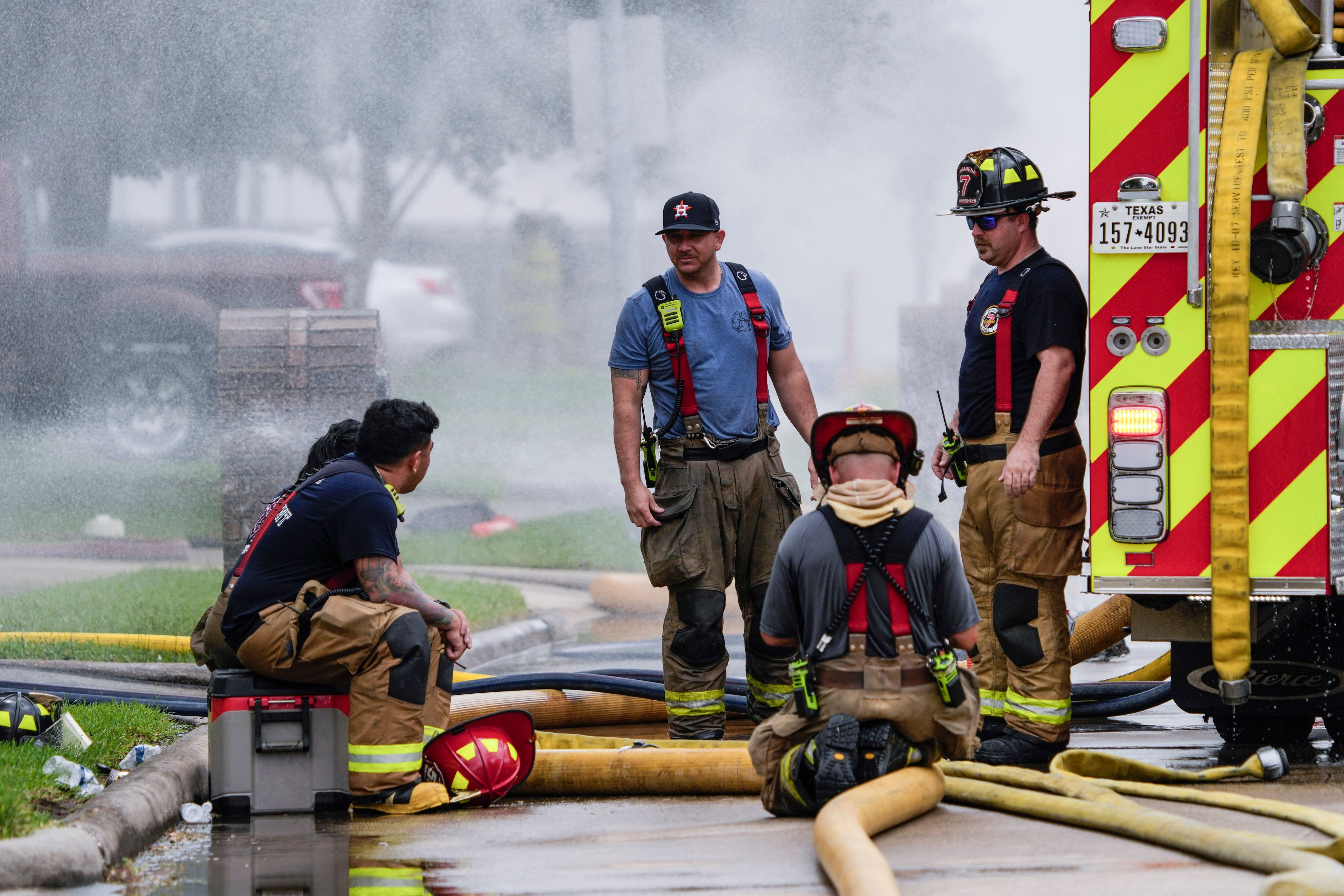 Firefighters take a break from battling a fire at a pipeline carrying liquified natural gas near Spencer Highway and Summerton on Monday, Sept. 16, 2024, in La Porte, Texas. (Brett Coomer/Houston Chronicle via AP)