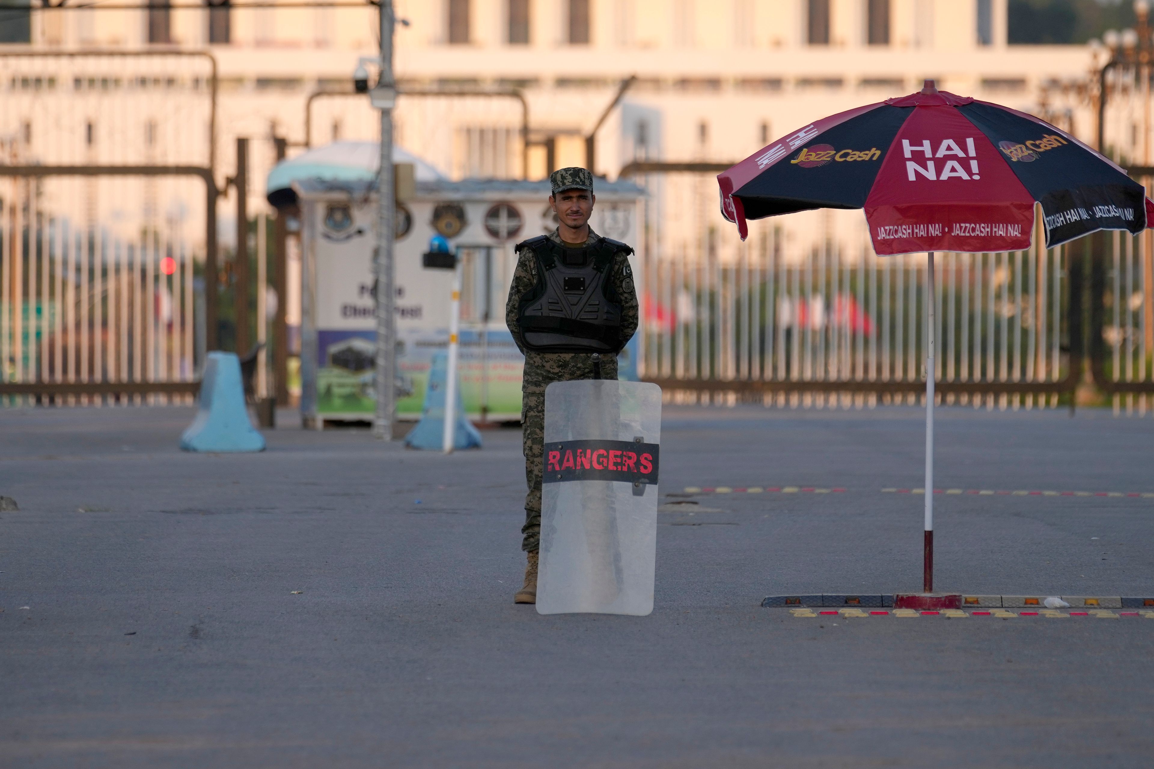 A paramilitary soldier stands guard at a barricaded road leading to Presidency, in background, and to the venue of the upcoming Shanghai Cooperation Organization (SCO) summit in Islamabad, Pakistan, Sunday, Oct. 13, 2024. (AP Photo/Anjum Naveed)