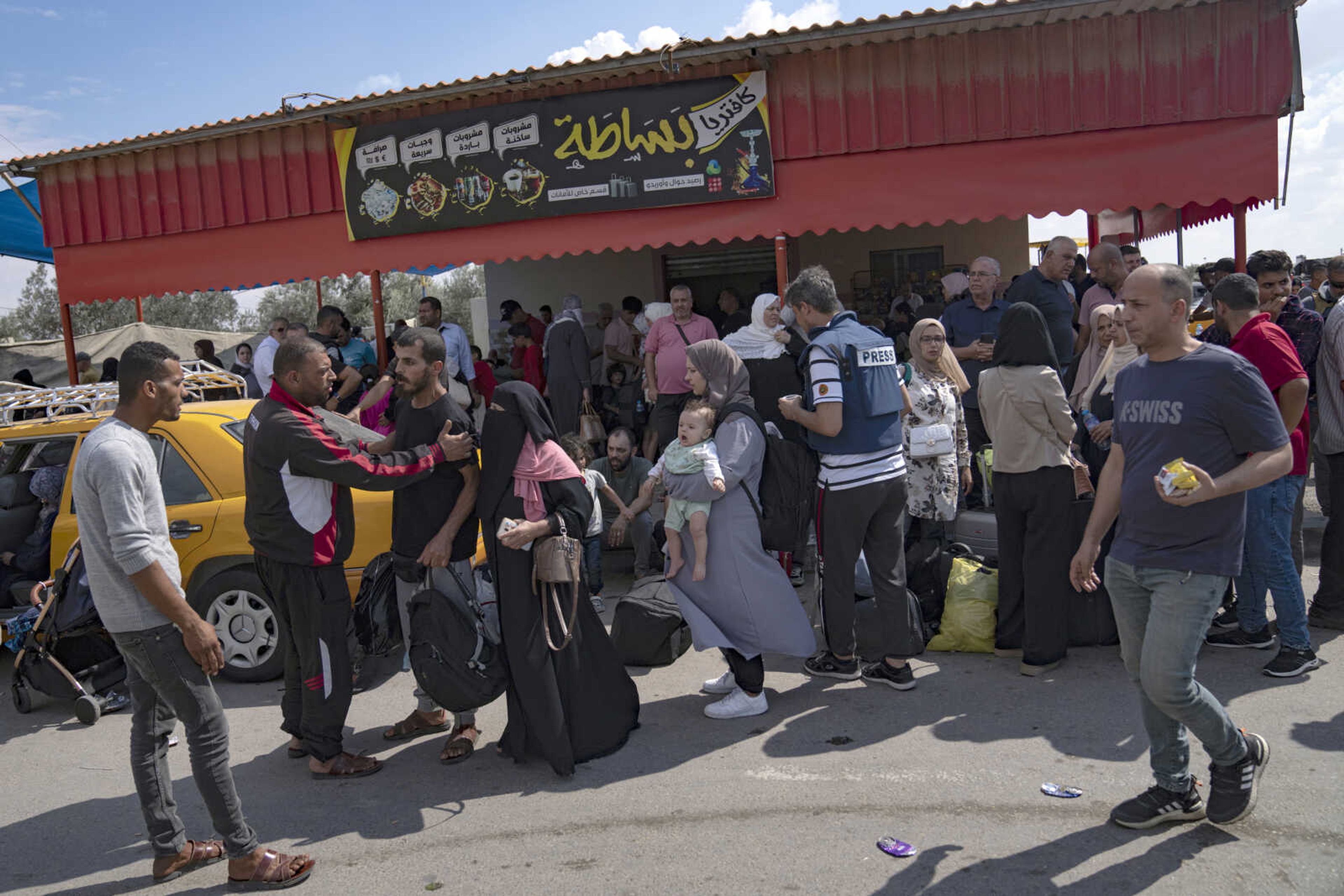 Palestinians wait to cross into Egypt at the Rafah border crossing Monday in the Gaza Strip.