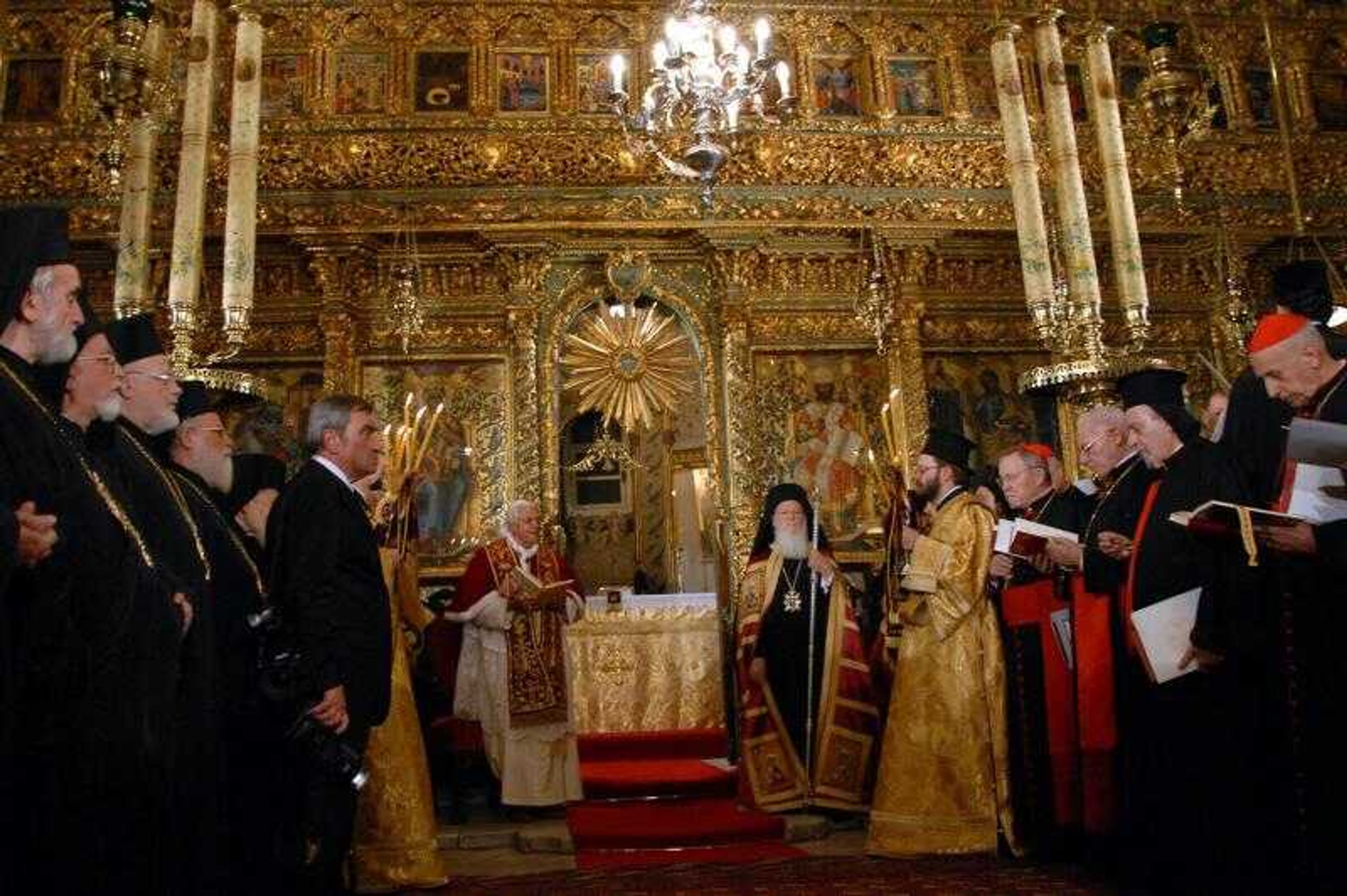 In this pictures provided by the Ecumenical Orthodox Patriarchate, Pope Benedict XVI and Ecumenical Orthodox Patriarch Bartholomew I pray the Patriarchal Cathedral of St. George at the Orthodox Patriarchate in Istanbul, Turkey, Wednesday, Nov. 29, 2006. The pope's visit to Turkey was born out of Benedict's desire to meet Bartholomew, who has his headquarters in Istanbul, once ancient Constantinople. The pontiff has been trying to foster better relations between the Orthodox and Catholics. (AP Photo/Nikos Manginas)