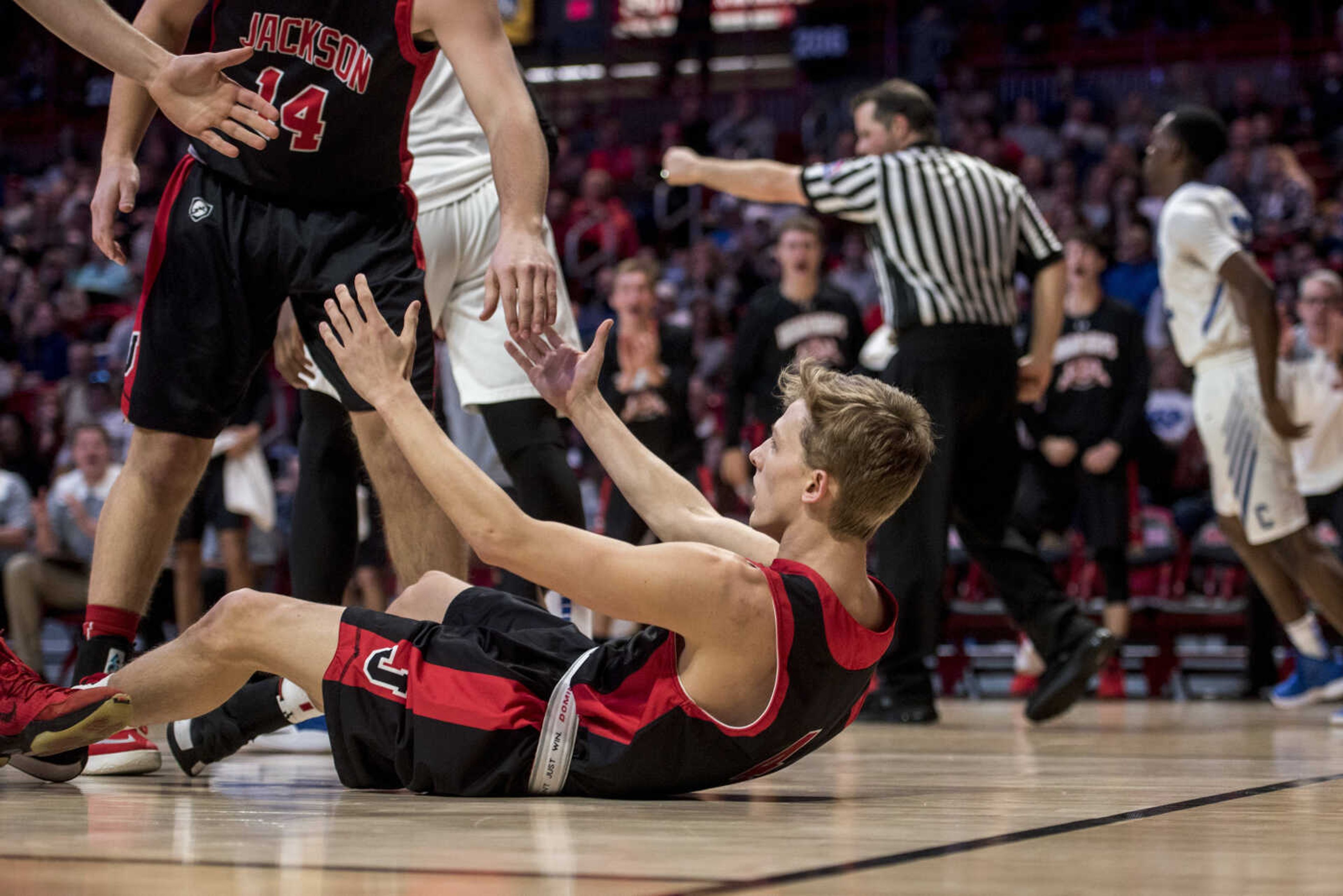 Jackson's Payton Salyer (4) is helped back to his feet after drawing a charge in the paint during a semifinal matchup against the Charleston Blue Jays at the Southeast Missourian Christmas Tournament Friday, Dec. 28, 2018.