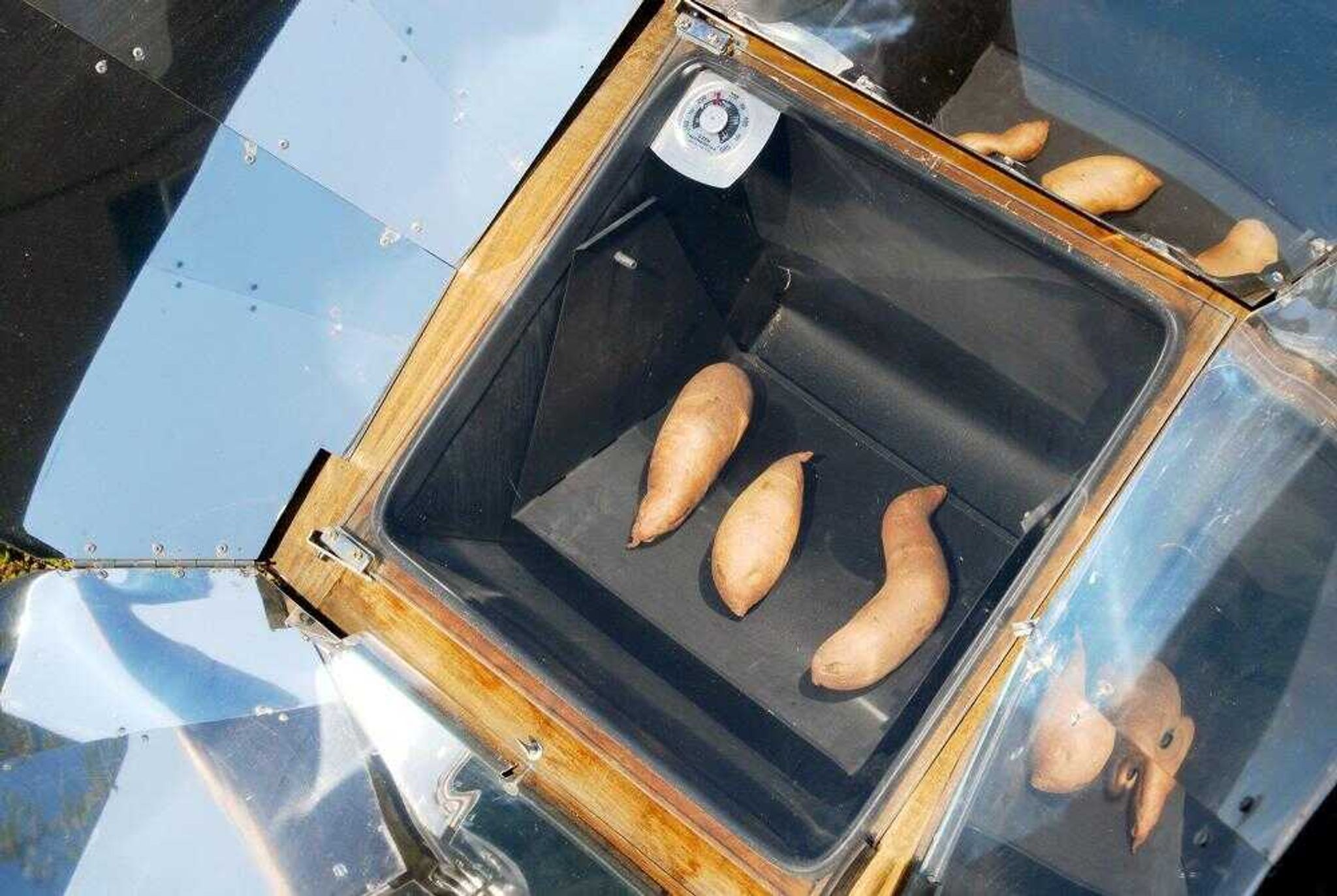 The Maginels used a Sun Oven to bake sweet potatoes. The oven's temperature can reach 300 degrees.