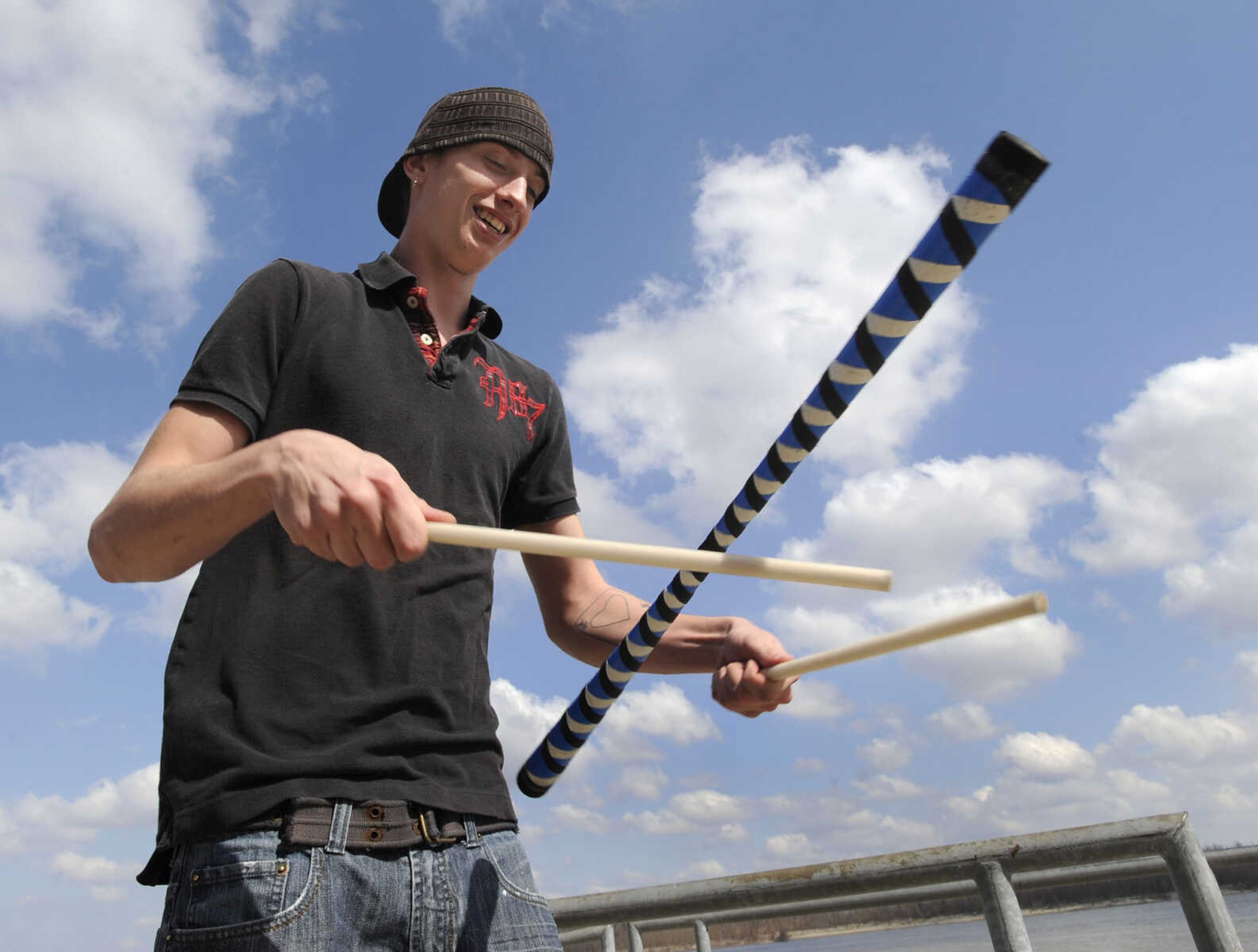 FRED LYNCH ~ flynch@semissourian.com
Corey Mann of Scott City juggles devil sticks on a warm Wednesday, March 10, 2010 at the Cape Girardeau riverfront. He has been sticking for about three months since seeing performers juggling sticks in St. Louis, "and I knew I had to do that," he said. Two handsticks are used to control the baton. For now, it's a hobby for Mann, but he said he might like to become a performer some day.