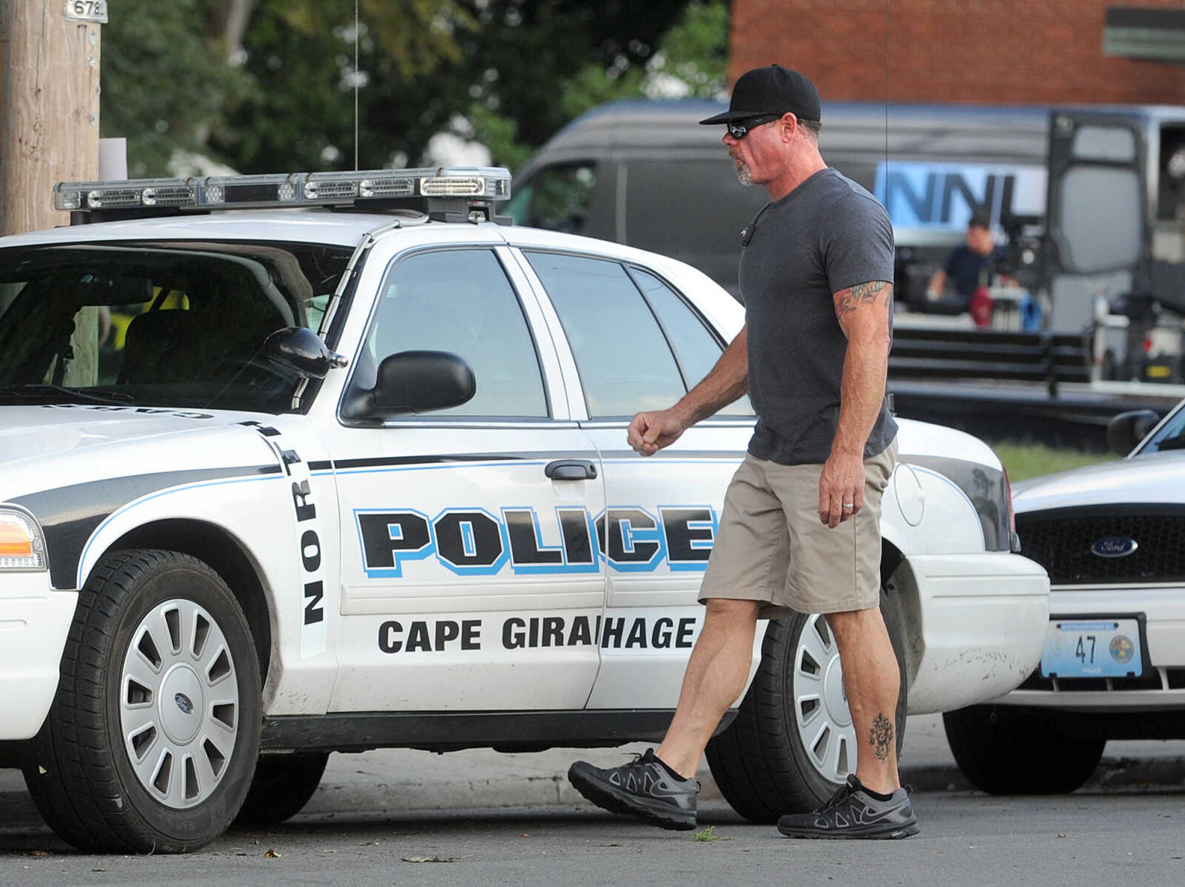 LAURA SIMON ~ lsimon@semissourian.com

A crew member adds magnetic strips to a Cape Girardeau Police Department cruiser to change the name to North Carthage for 20th Century Fox's feature film "Gone Girl", Thursday, Oct. 3, 2013.