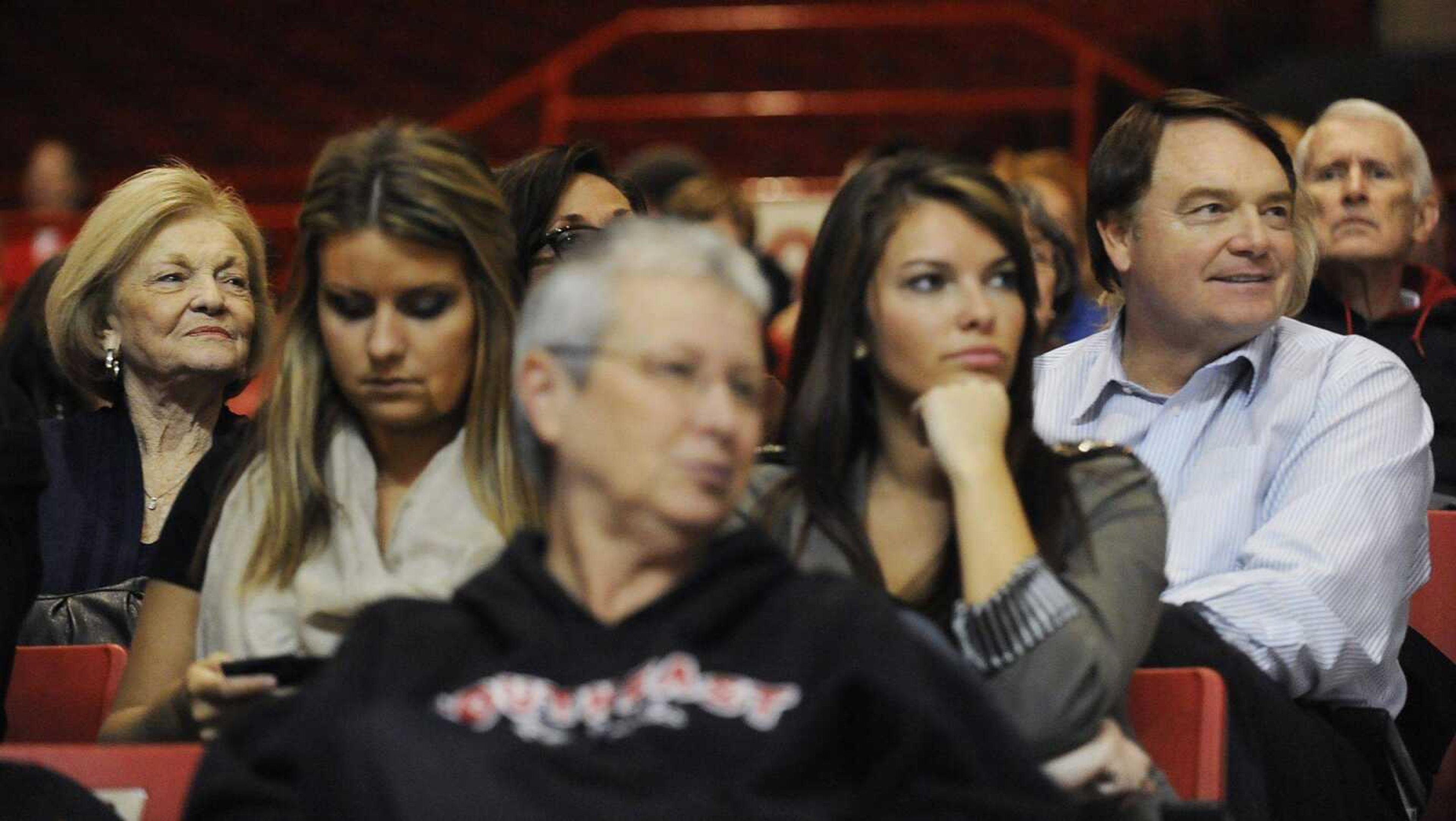 Former college football coach and current CBS college football analyst Houston Nutt, right, sits with his wife Diana (not visible) and mother Emogene, far left, and other family members to watch brothers Southeast Missouri State coach Dickey and Ouachita Baptist coach Dennis as their two teams played an exhibition game Tuesday at the Show Me Center.