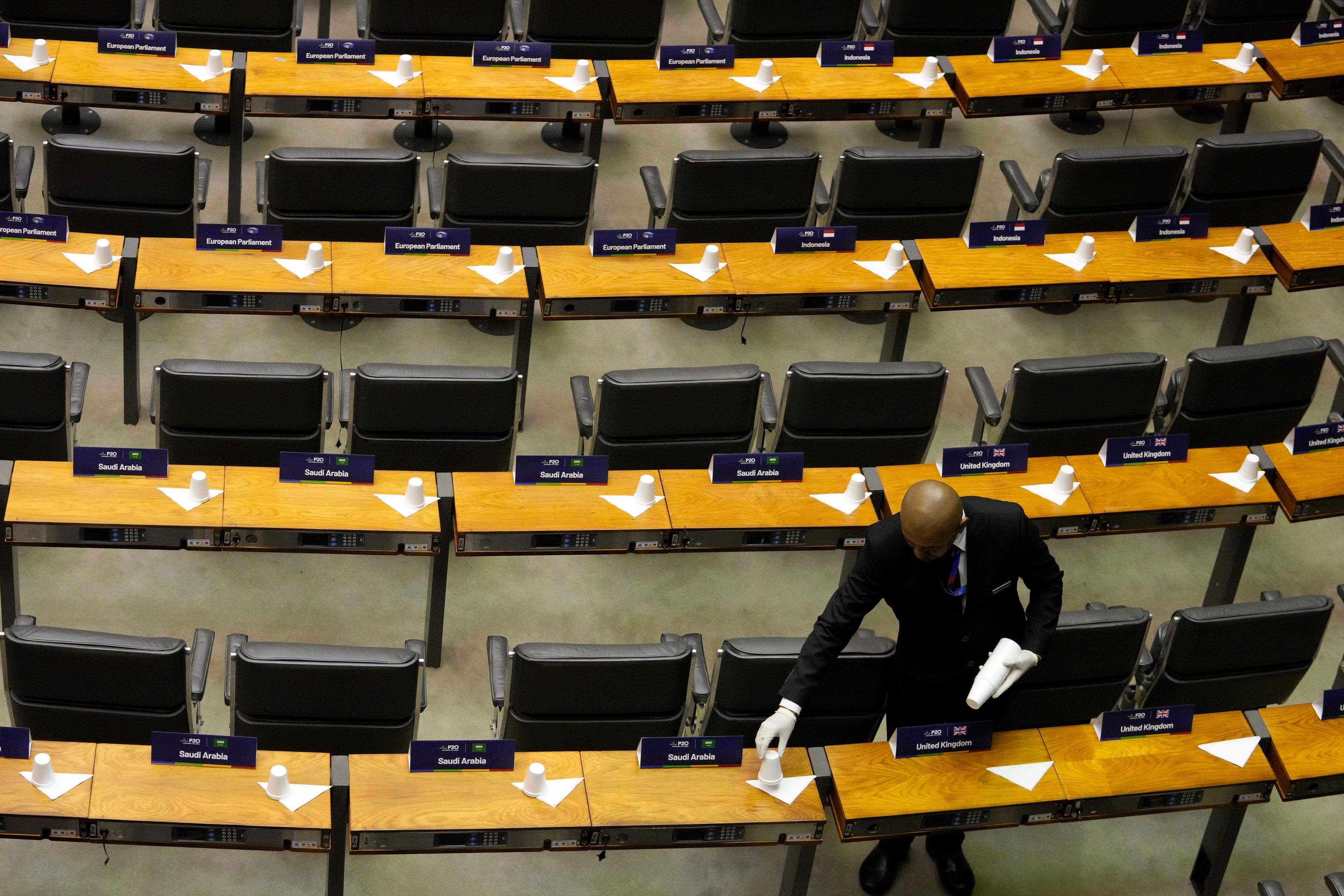 A waiter places cups before the opening ceremony of the 10th Presidents of the G20 Parliaments Summit at the National Congress in Brasilia, Brazil, Thursday, Nov. 7, 2024. (AP Photo/Eraldo Peres)