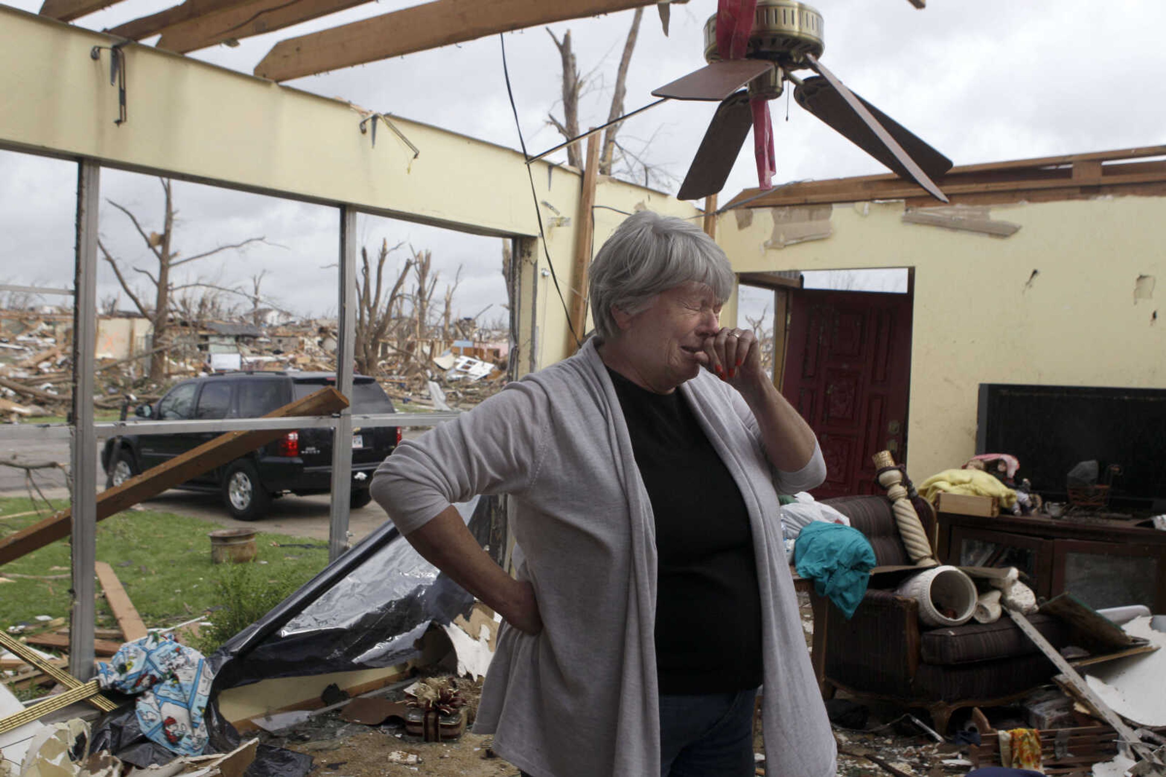 Shirley Waits cries as she stands in what is left of her mother's home Wednesday, May 25, 2011, in Joplin , Mo. A massive tornado moved through Joplin Sunday night leveling much of the city. (AP Photo/Jeff Roberson)