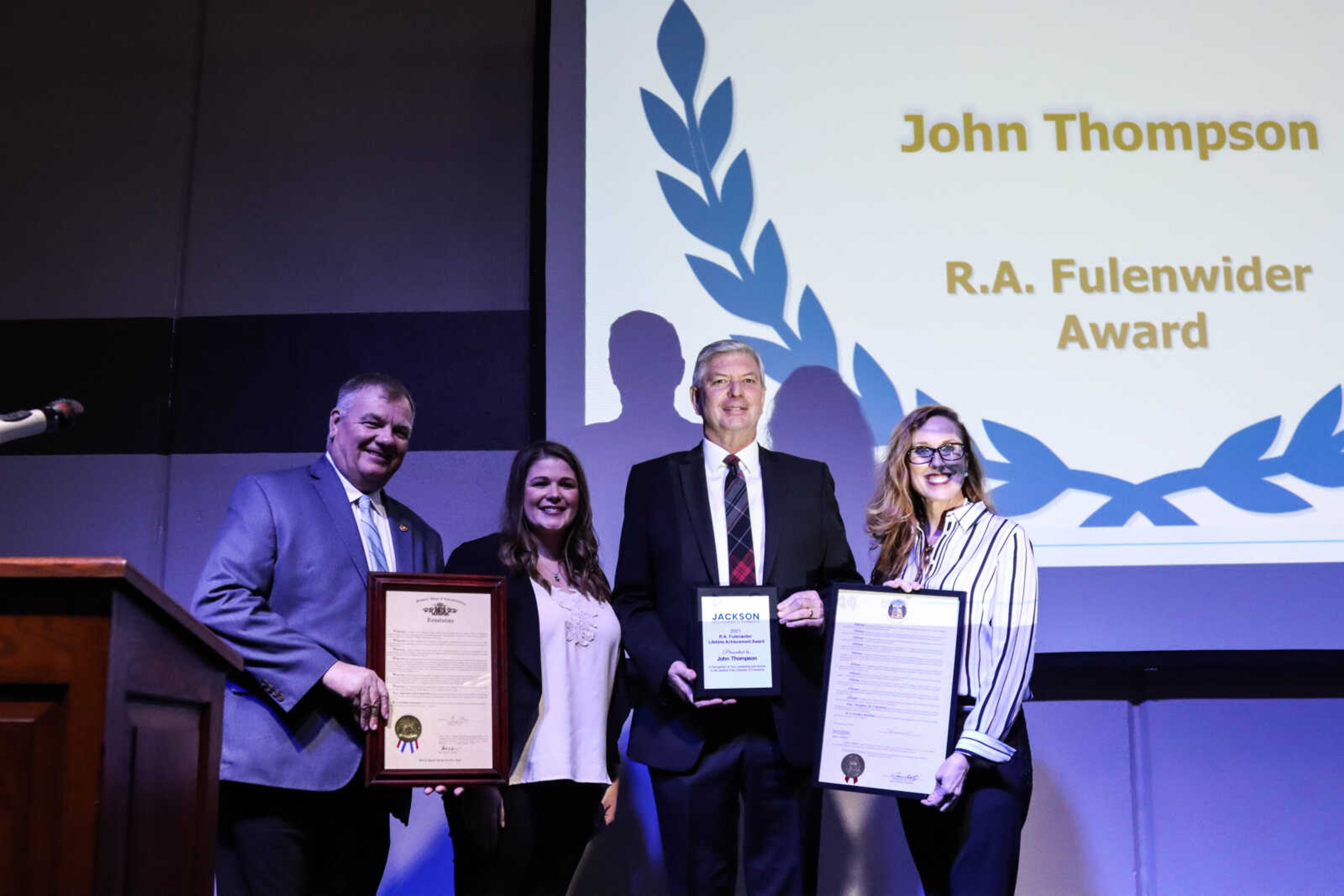 John Thompson, second from right, receives the R.A. Fulenwider award presented by First Midwest Bank.