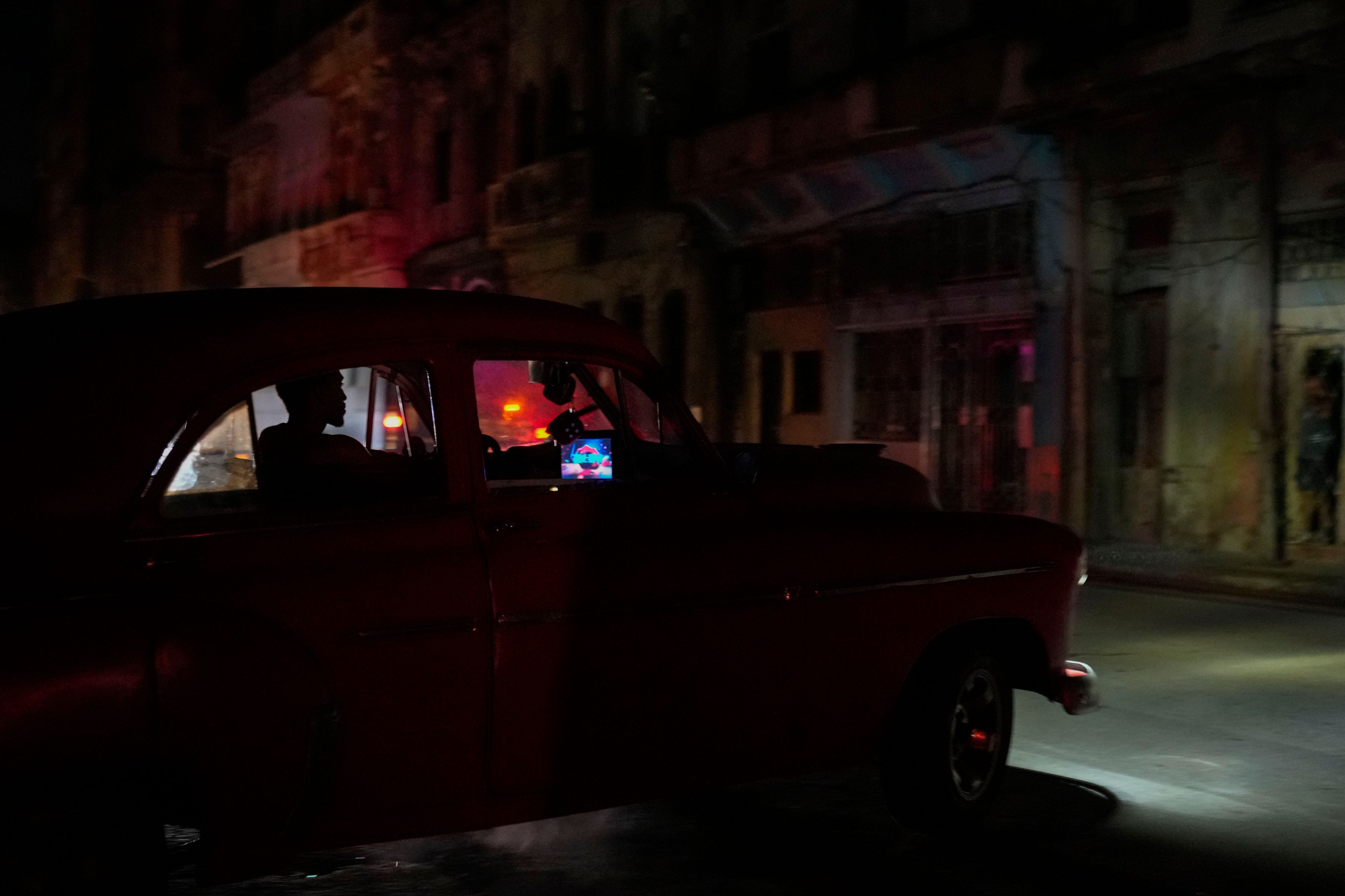 A man drives his American classic car during a massive blackout after a major power plant failed in Havana, Cuba, Friday, Oct. 18, 2024. (AP Photo/Ramon Espinosa)