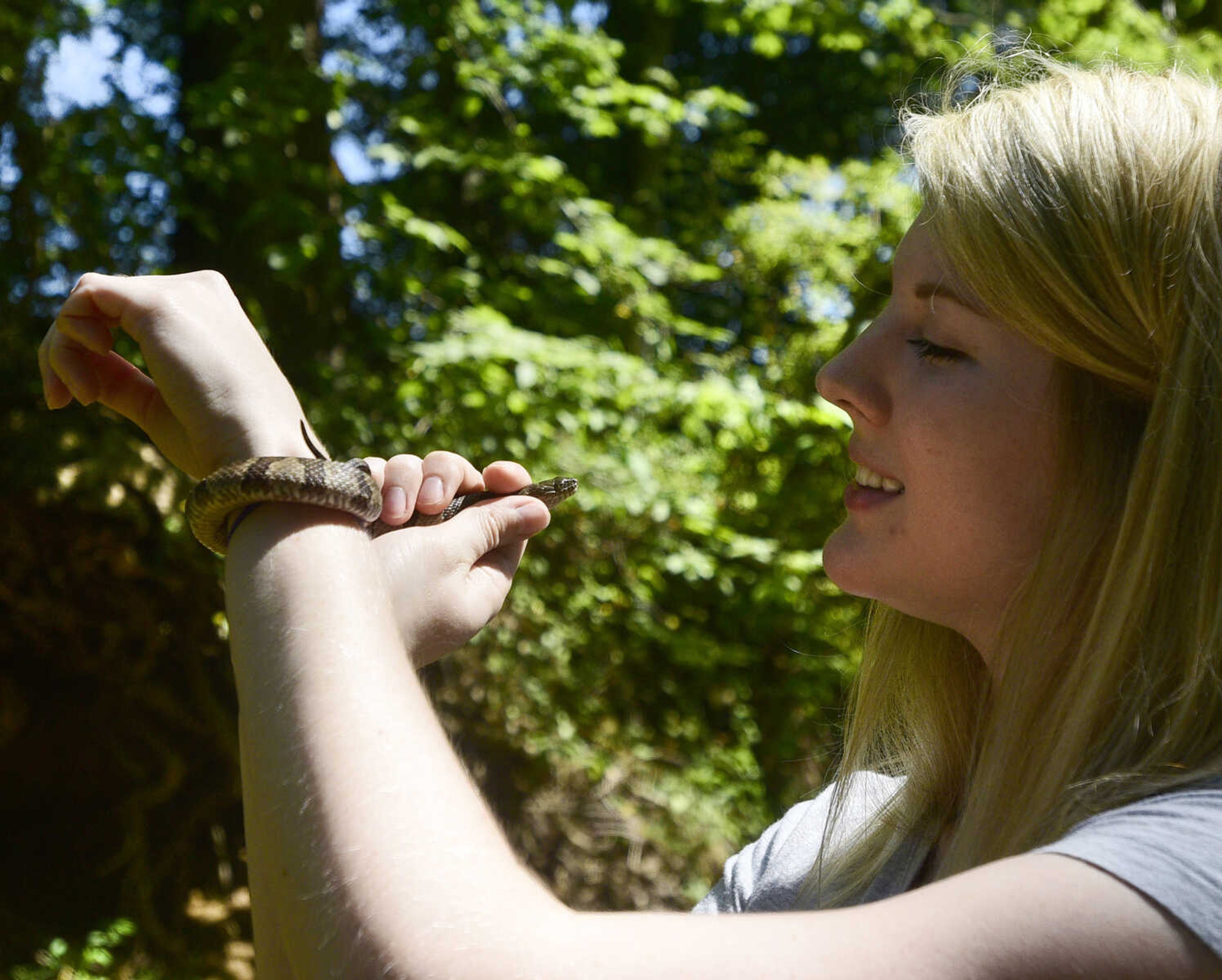 Jordyn Richmond handles a Northern Water Snake she and Anna Mae Zembsch found in Little Indian Creek near Oriole, Missouri.