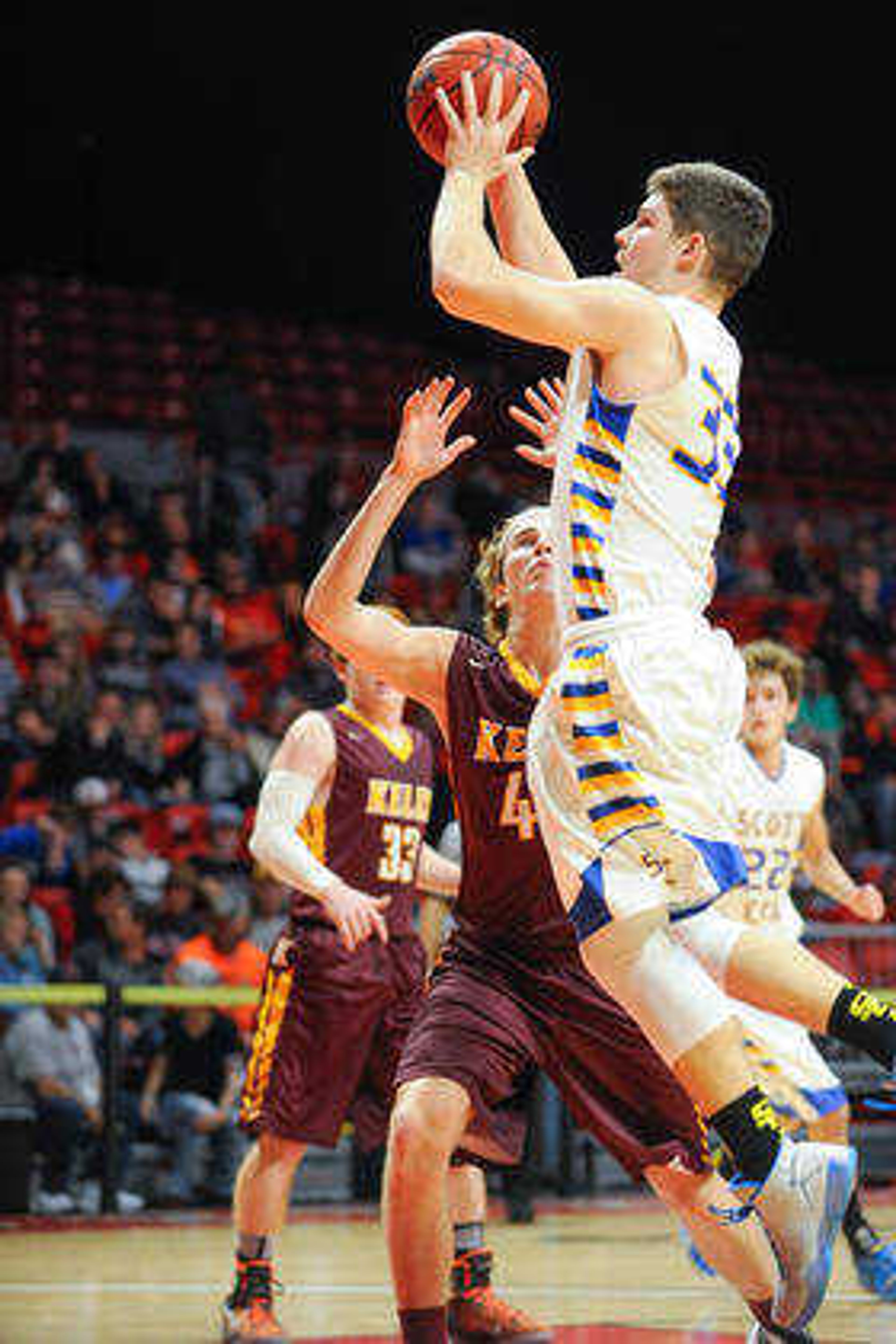 Scott City's Braden Cox shoots over Kelly's Conner Dittlinger during the second quarter in a first-round game of the Southeast Missourian Christmas Tournament Saturday, Dec. 26, 2015 at the Show Me Center. (GLENN LANDBERG)