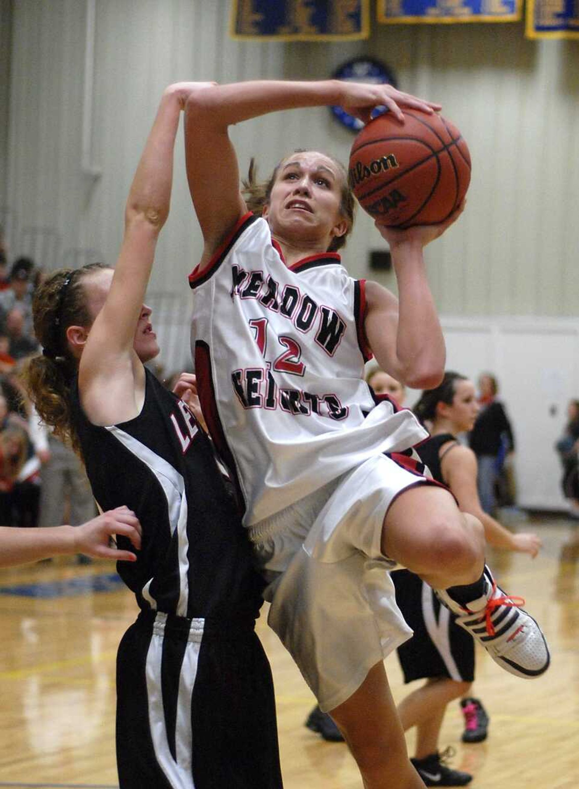 Meadow Heights' Erin Bollmann shoots against Lesterville's Taylor Cook during the second quarter of the Class 2 District 3 title game Thursday in Oran, Mo. Meadow Heights won 84-50. (Kristin Eberts)