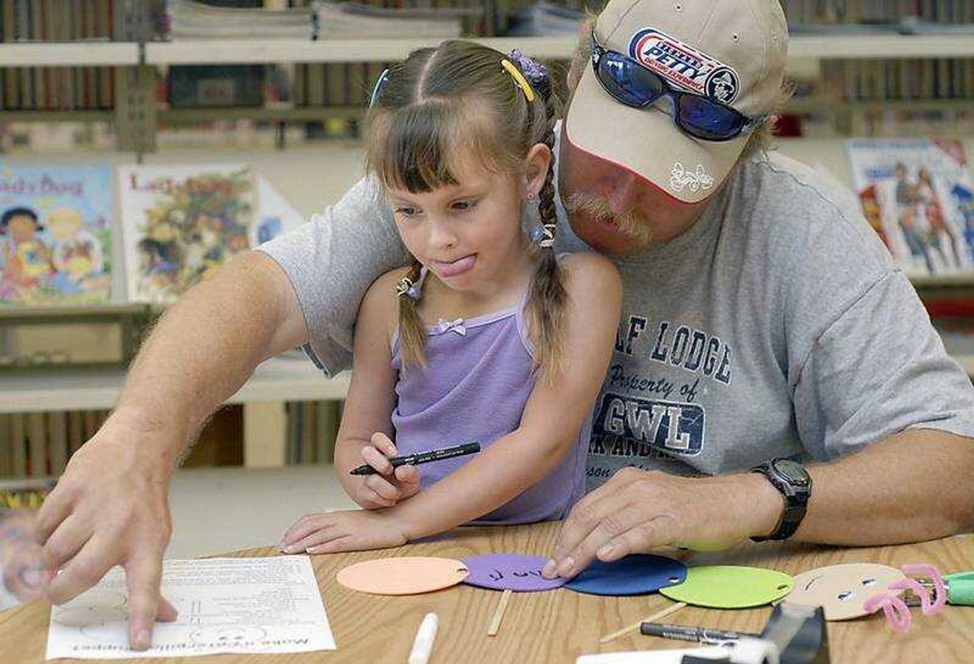 KIT DOYLE ~ kdoyle@semissourian.com
Curtis Sparks helped his daughter Charli Jo Sparks, 4, write her name on the caterpillar that they made Saturday morning, July 12, 2008, during a 'Catch the Reading Bug' Youth Services Program  at the Cape Girardeau Public Library.