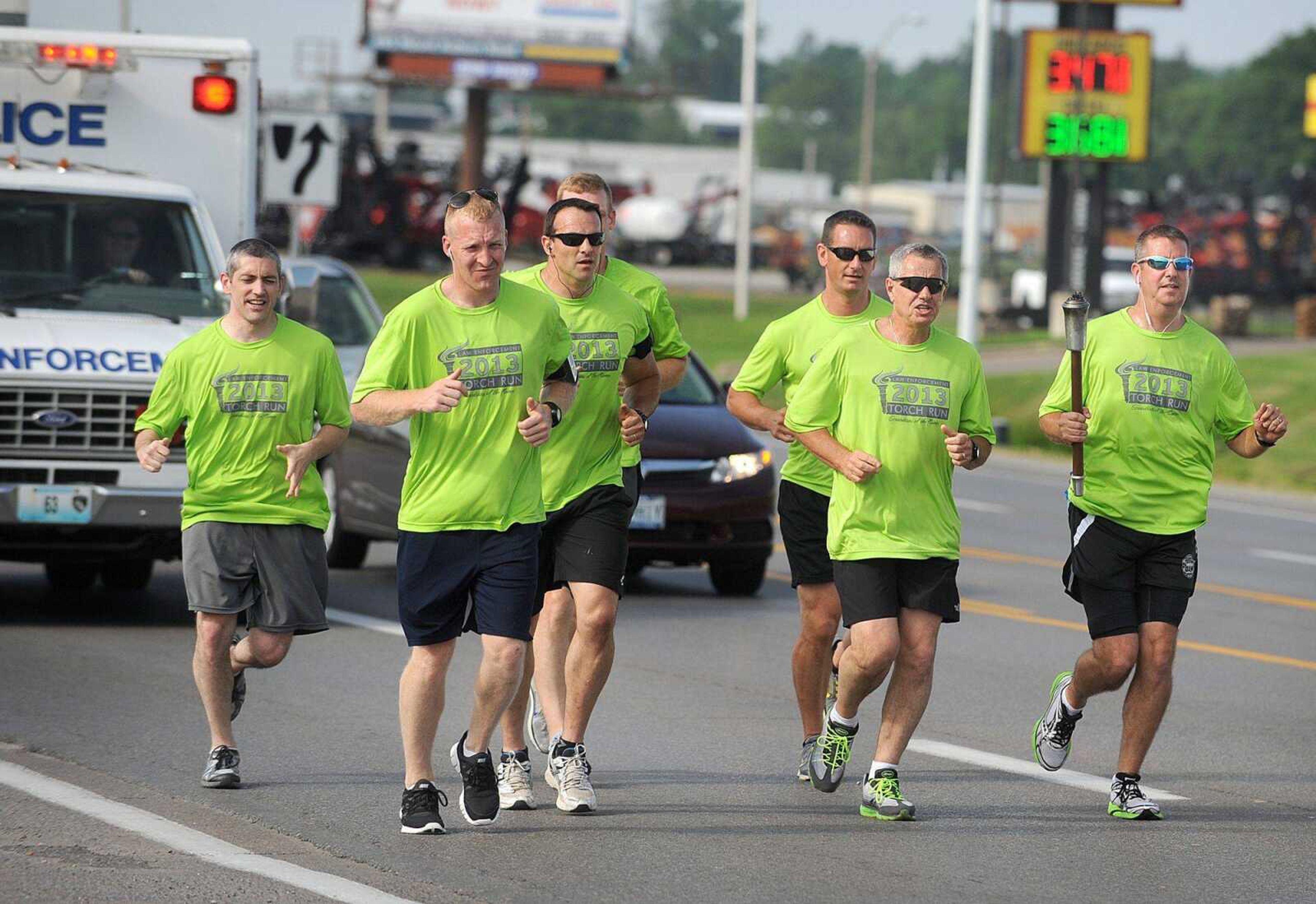 From left, Adam Glueck, Cody Farrow, Joey Hann, Keith Green, Ty Metzger, Kevin Orr and Brad Smith with the Cape Girardeau Police Department run north on Kingshighway on Tuesday during the Law Enforcement Torch Run for Special Olympics. The Flame of Hope is heading to Columbia, Mo., for the start of the Special Olympics State Summer Games at the University of Missouri. More than 950 runners are participating in the annual torch run. (Laura Simon)