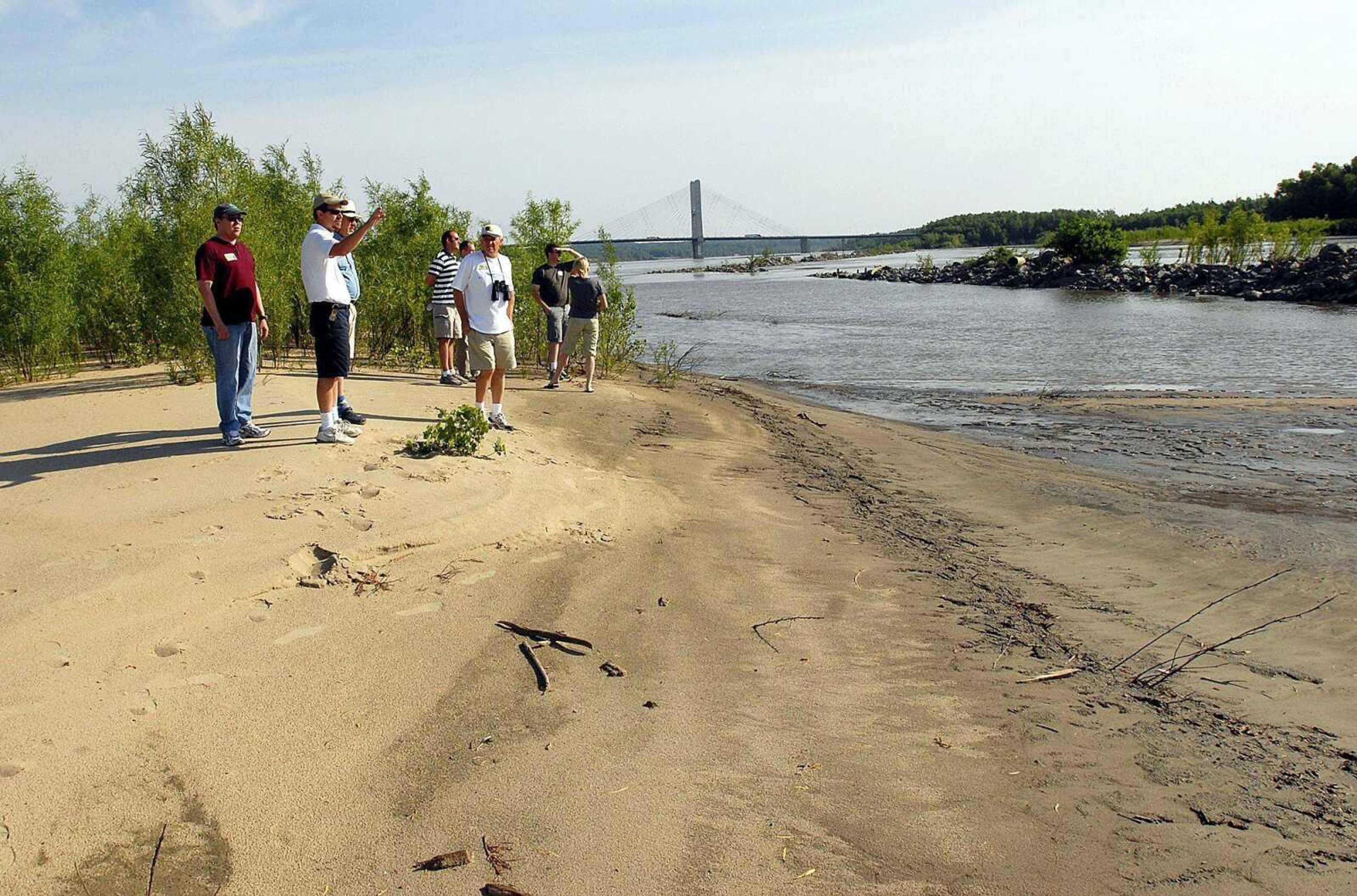 The Missouri Department of Conservation is considering the purchase of Marquette Island, which is just south of the Bill Emerson Memorial Bridge. In this photo from June 2007, members of the U.S. Fish and Wildlife Services, The Nature Conservancy and the Corps of Engineers view the Marquette Island on the Mississippi River south of Cape Girardeau. (File photo by Kit Doyle)