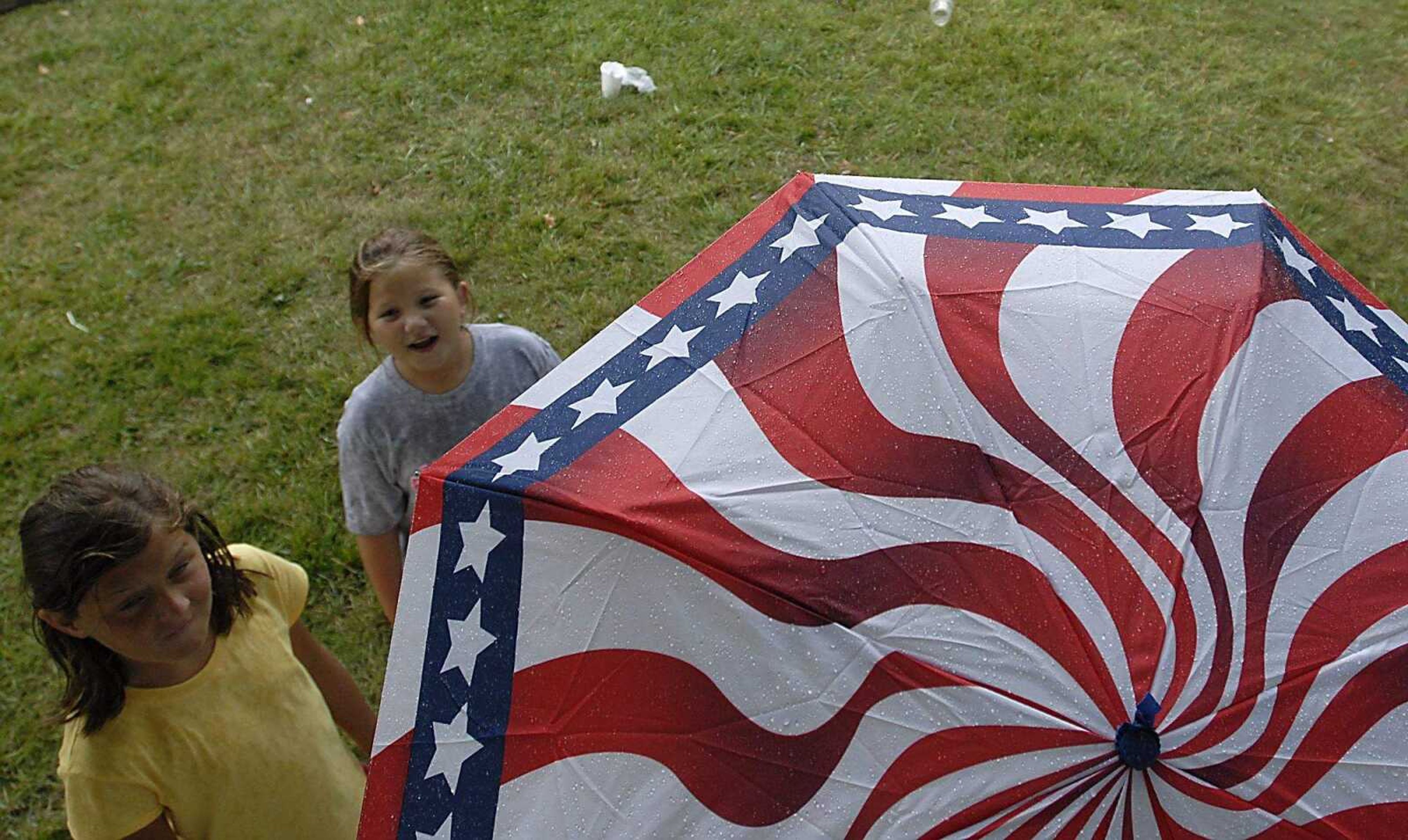 KIT DOYLE ~ kdoyle@semissourian.com
Umbrellas came out as rain began to fall Friday, July 25, 2008, at Jackson Homecomers.