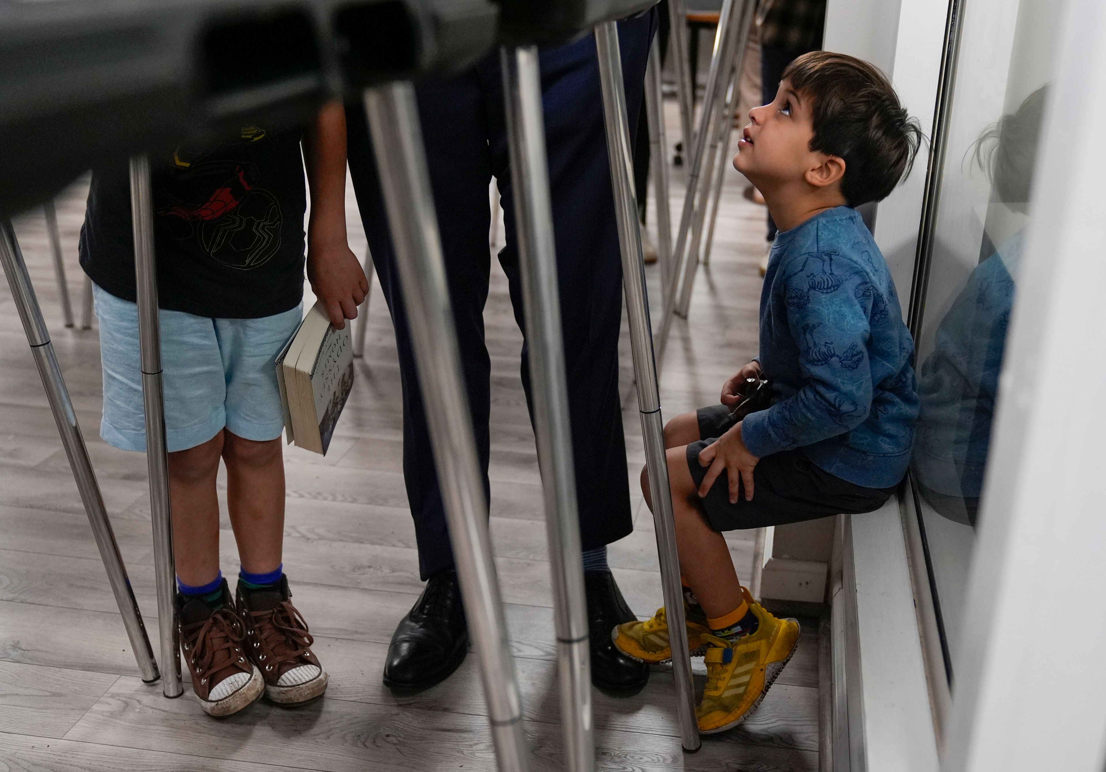 Republican vice presidential nominee Sen. JD Vance, R-Ohio, center, votes with his sons at the St Anthony of Padua Maronite Catholic Church on election day, Tuesday, Nov. 5, 2024, in Cincinnati. (AP Photo/Carolyn Kaster)