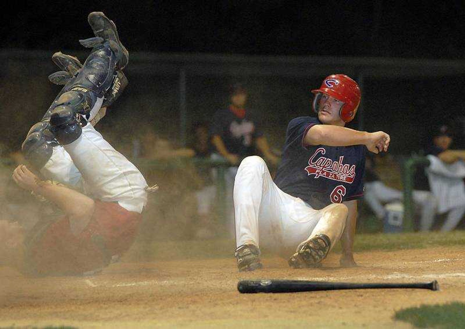 FRED LYNCH ~ flynch@semissourian.com
ABOVE: Kendal Deason scored for the Capahas as Evansville catcher Steve McNabb took a tumble on the fifth-inning play during Friday's game at Capaha Field. BELOW: Zach Johnson was tagged out by McNabb as he tried to follow Deason home on the same play.