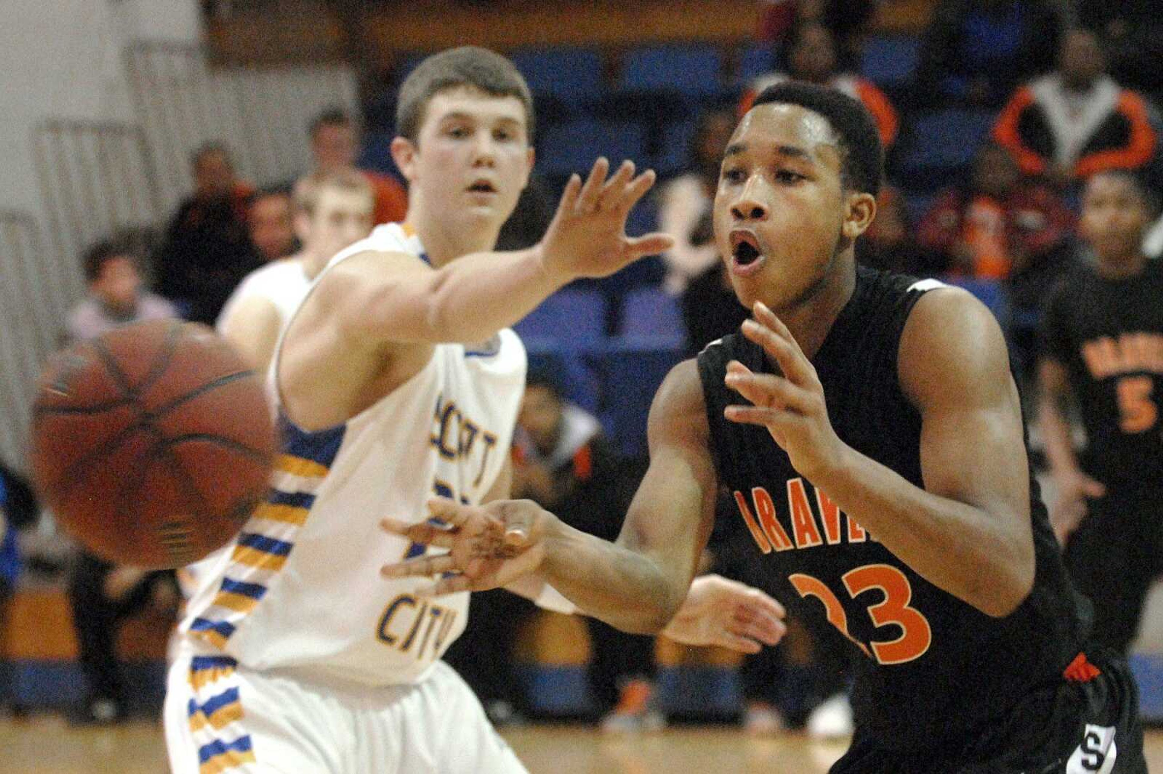 Scott County Central's Dominique Porter passes around Scott City defender Jonathan McFall during their game last month in Scott City. (Laura Simon)