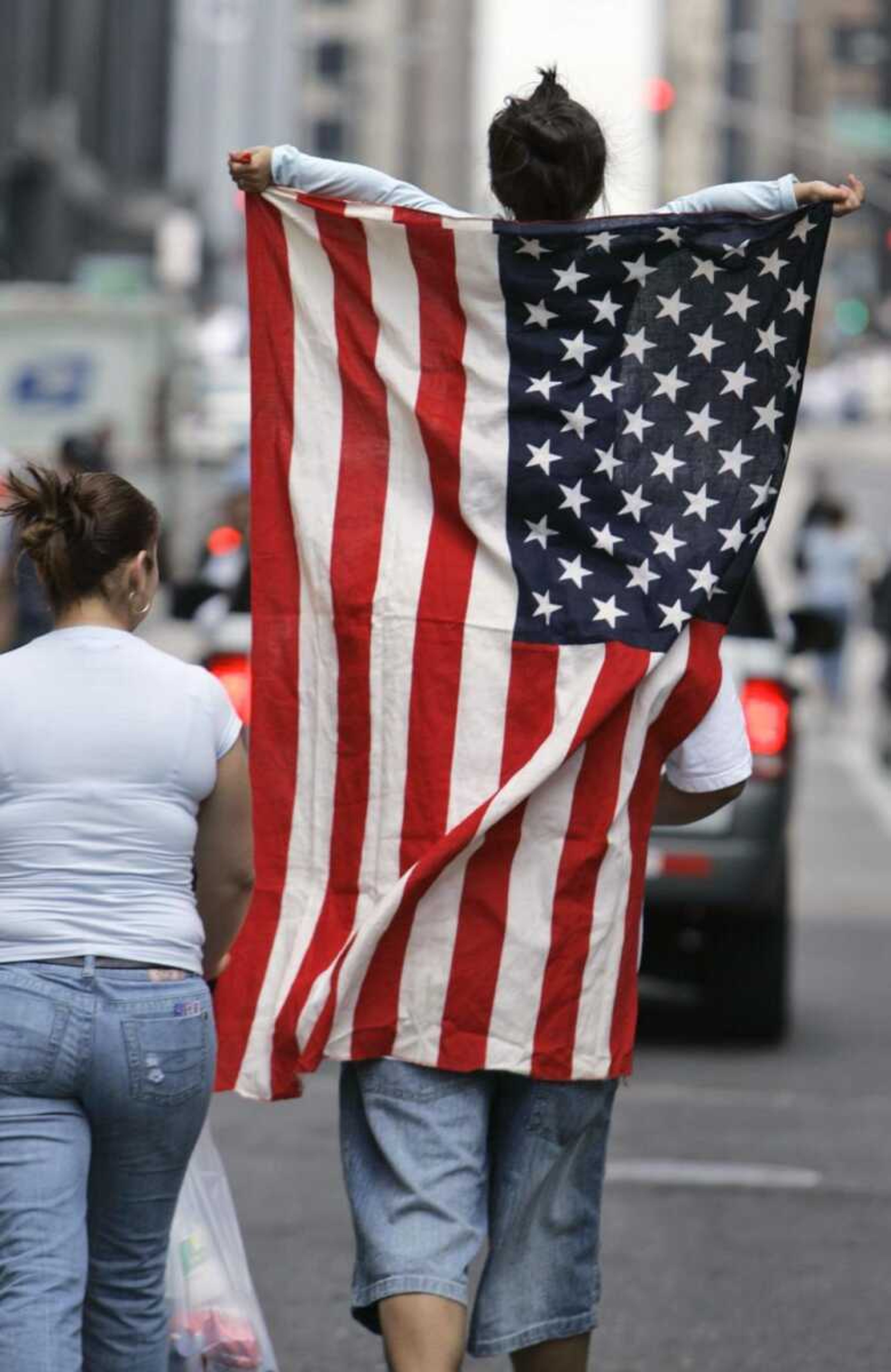 Jessica Reyes, 5, held an American flag as she participated in an immigration rights march Tuesday with her parents, Mario and Isabella, in Chicago. (Nam Y. Huh ~ Associated Press)