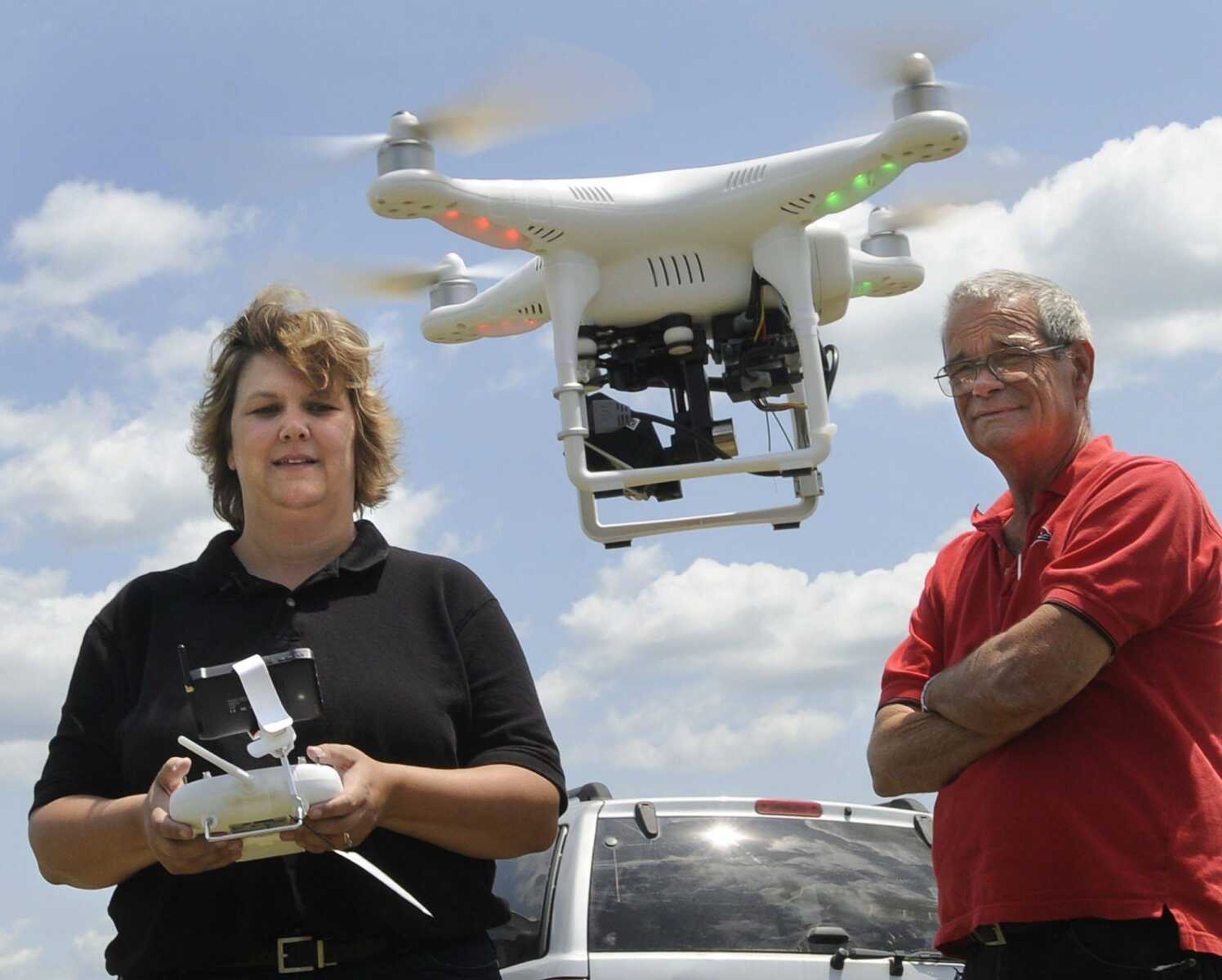 Dr. Indi Braden, associate professor of agriculture at Southeast Missouri State University, demonstrates a drone Tuesday with Dr. Mike Aide, chairman of the university's agriculture department, at the David M. Barton Agriculture Research Center near Gordonville. (Fred Lynch)