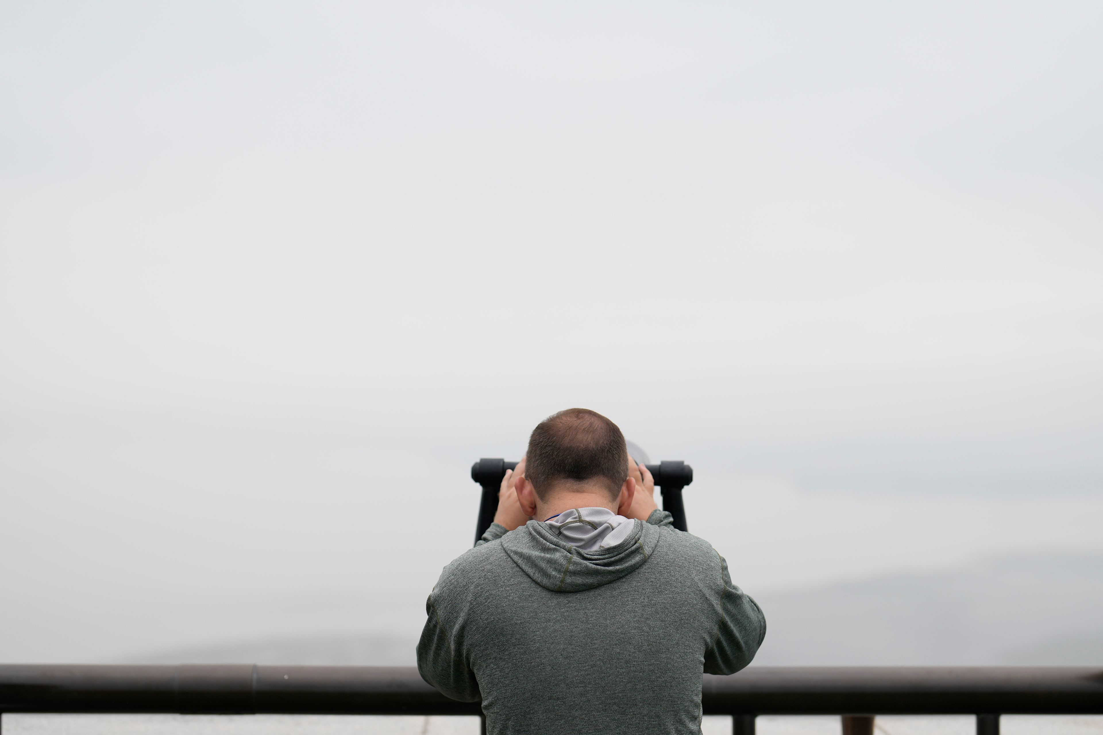 A visitor uses binoculars to see the North Korean side from the unification observatory in Paju, South Korea, Tuesday, Oct. 15, 2024. (AP Photo/Lee Jin-man)