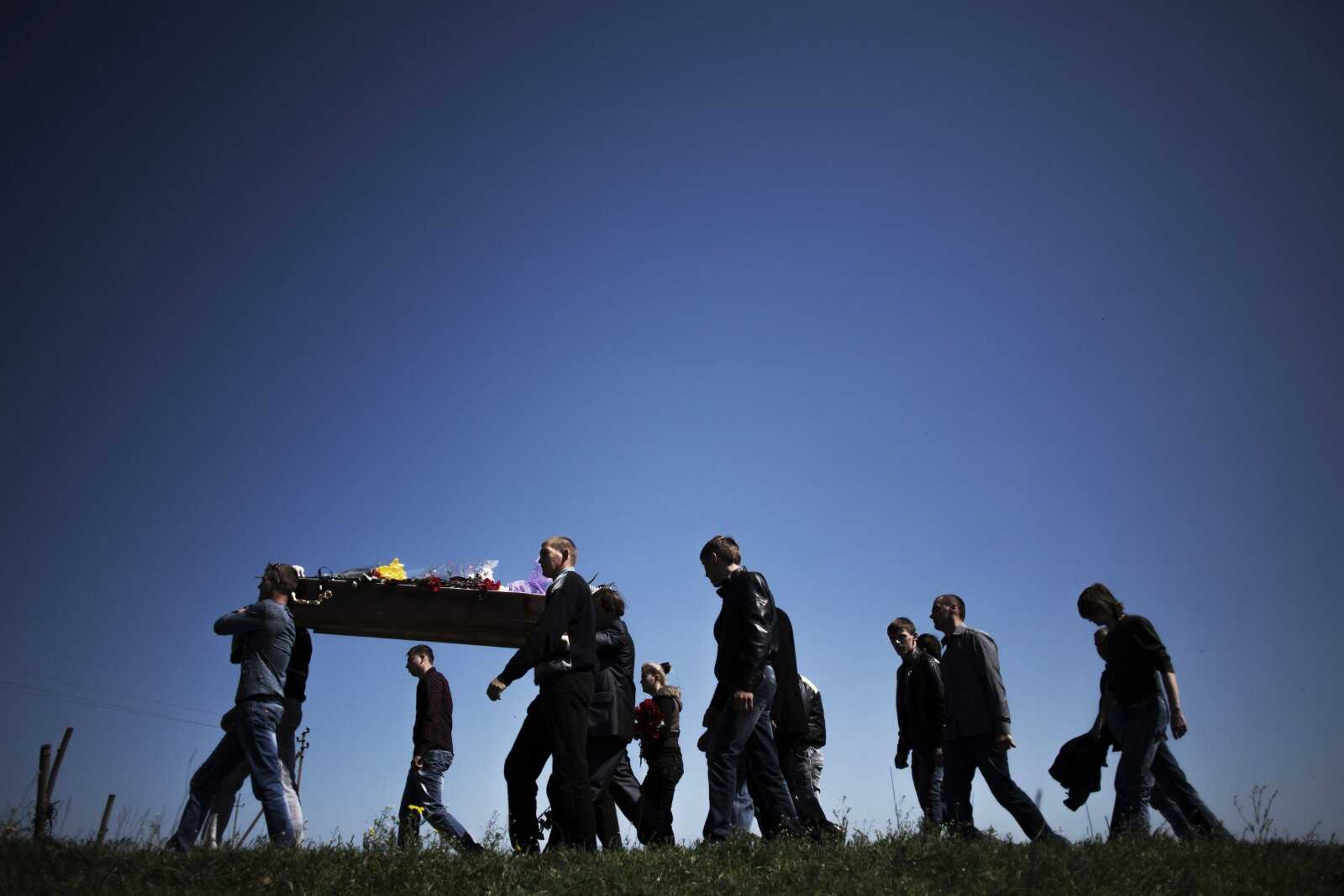 Friends and relatives carry a coffin bearing Lubenec Alexander Vladimirovich, 22, a pro-Russia militia member killed during clashes with the Ukrainian Army at a checkpoint on the outskirts of Slavyansk, ahead of his burial Saturday in the village of Hretishye, Ukraine. (Manu Brabo ~ Associated Press)