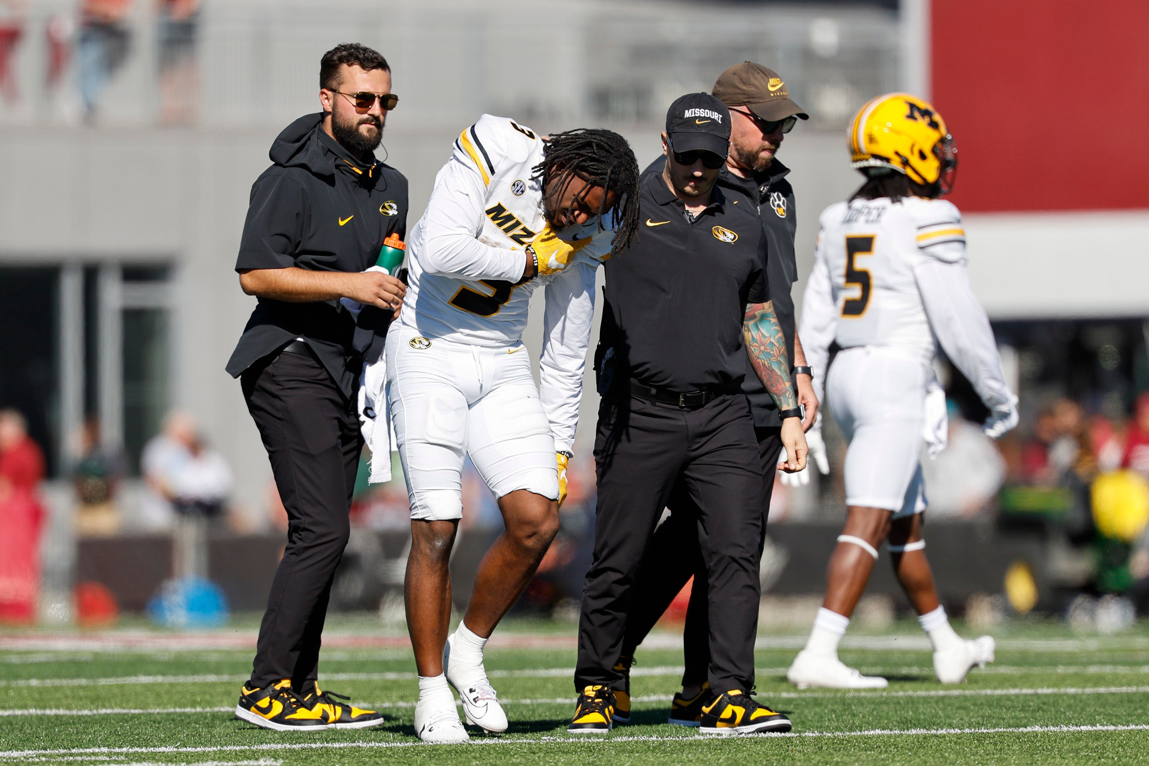 Missouri wide receiver Luther Burden III (3) is helped off the field by trainers during the second half of an NCAA football game against Massachusetts, Saturday, Oct. 12, 2024, in Amherst, Mass. (AP Photo/Greg M. Cooper)