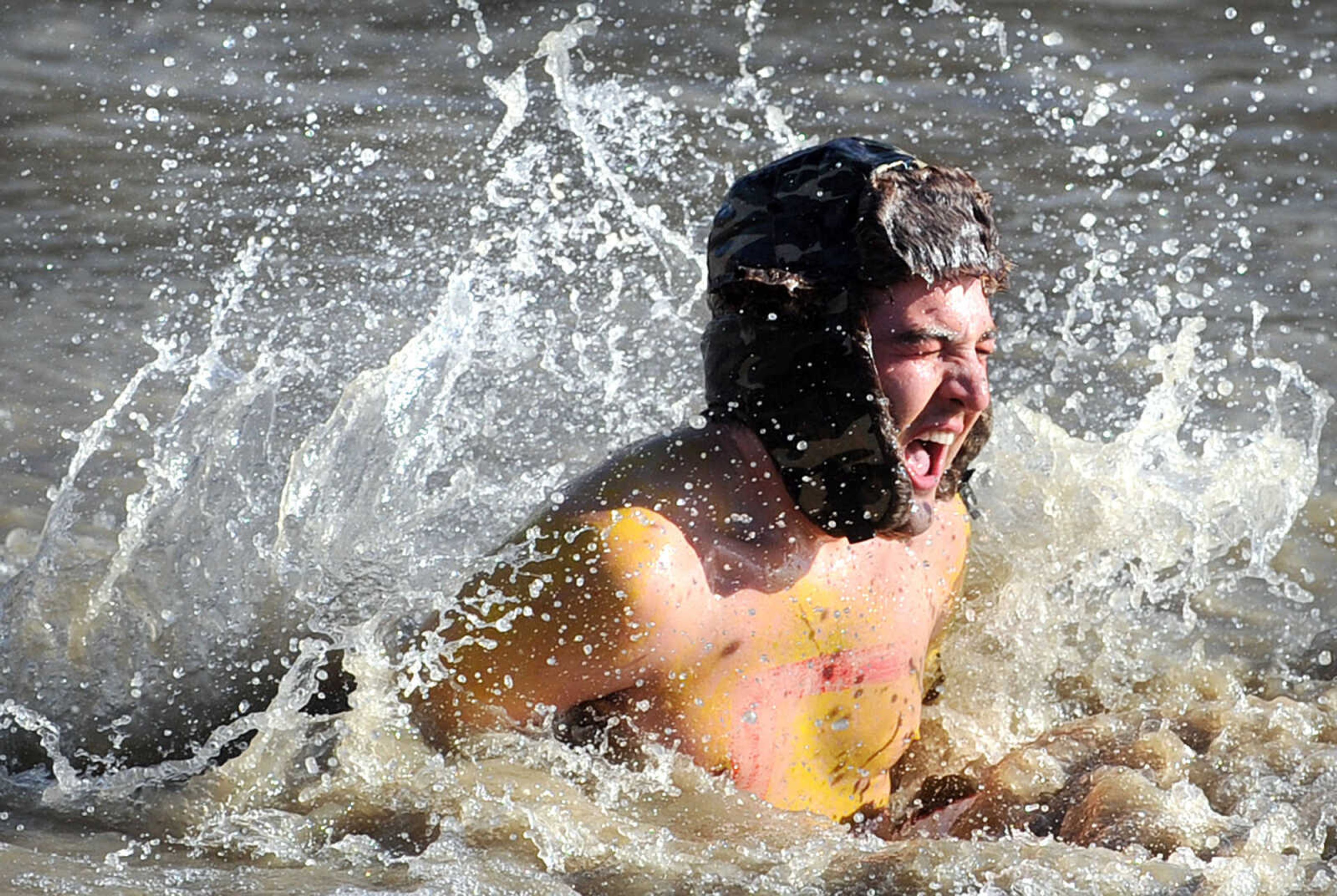 LAURA SIMON ~ lsimon@semissourian.com
People plunge into the cold waters of Lake Boutin Saturday afternoon, Feb. 2, 2013 during the Polar Plunge at Trail of Tears State Park. The lake's water temperature Saturday was 28 degrees. Thirty-six teams totaling 291 people took the annual plunge that benefits Special Olympics. Each team has to raise a minimum of 75 dollars to participate.