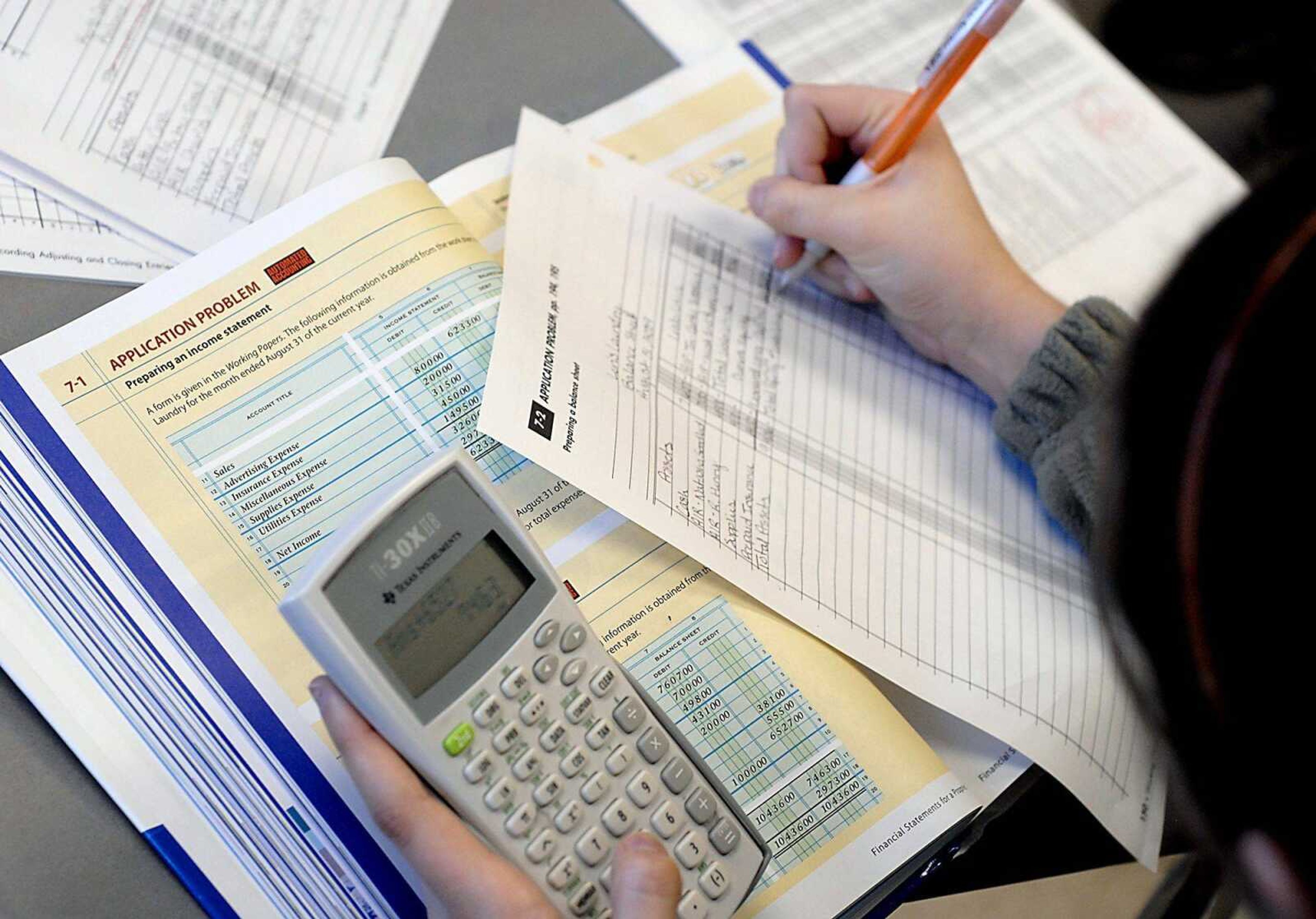 Central senior Madison Putney, 17, uses a calculator to complete an accounting worksheet Thursday.