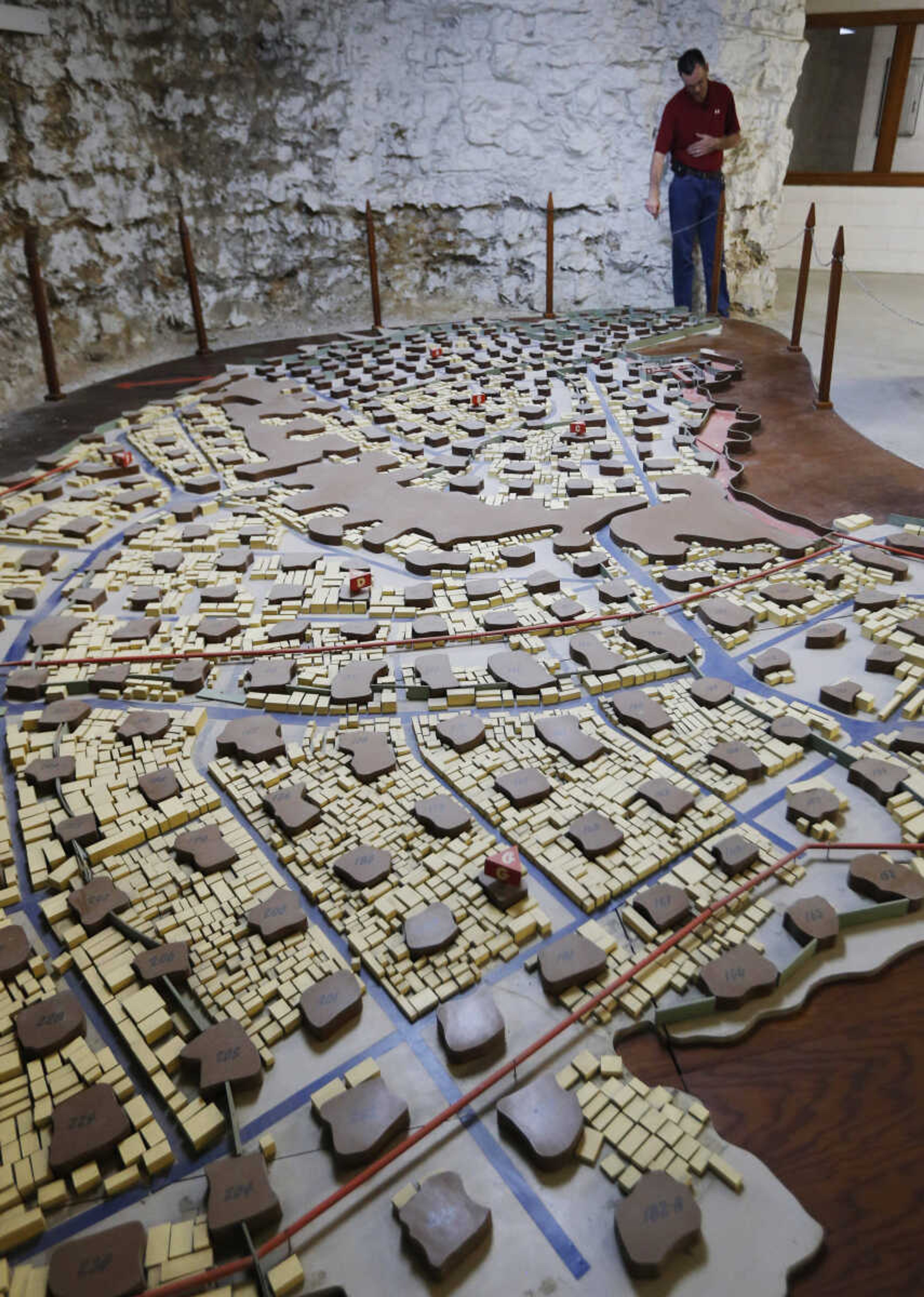 Coby Cullins stands next to a scale model of the Vivos Shelter and Resort during a tour of the facility in Atchison, Kan., Tuesday, June 18, 2013. A California man is creating what he calls the world's largest private underground survivor shelter, using a complex of limestone caves dug more than 100 years ago beneath gently rolling hills overlooking the Missouri River. (AP Photo/Orlin Wagner)