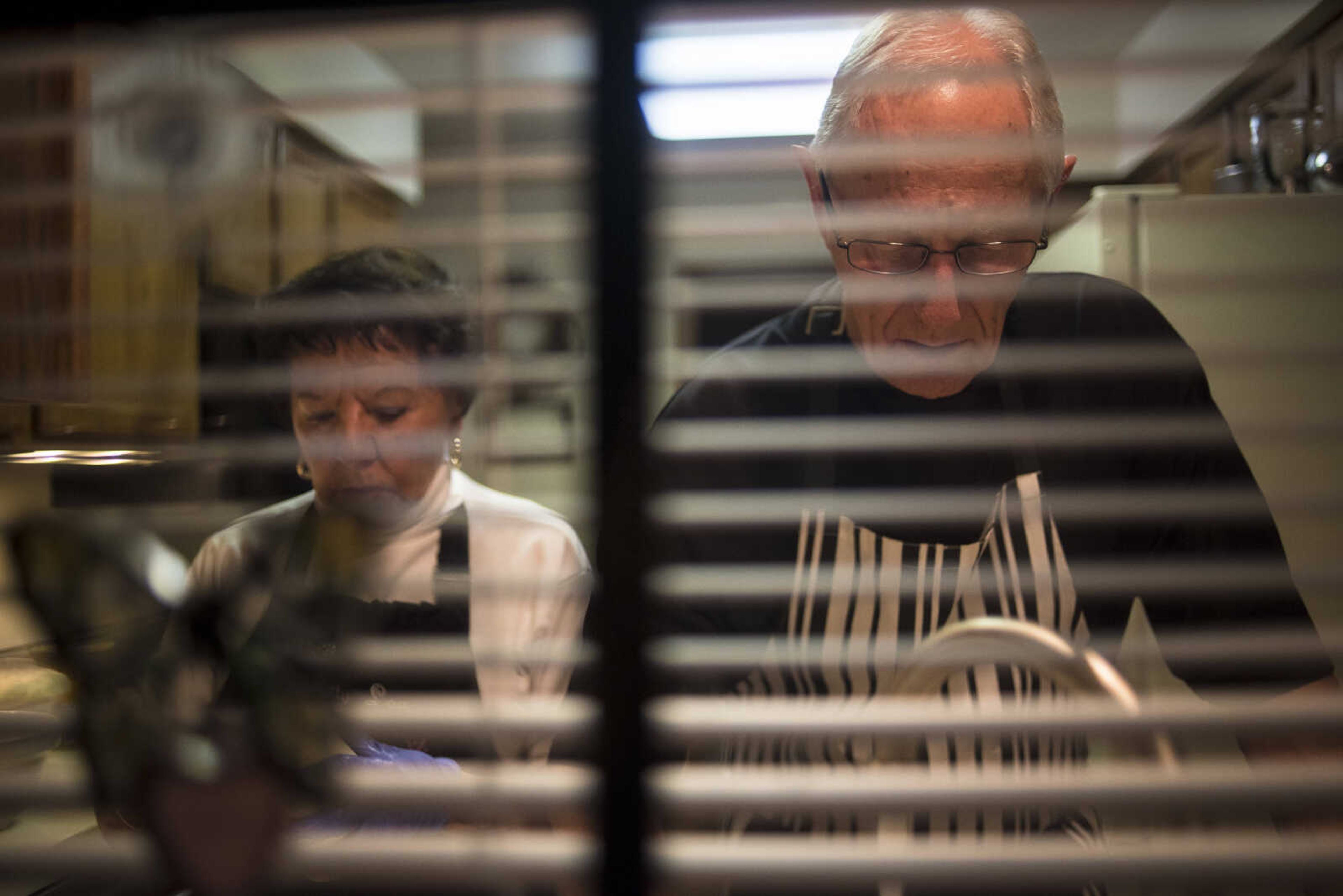 Betty Lou Vogel and Don Vogel wash dishes while they let sourdough bread and cinnamon rolls rise before baking Monday, Oct. 9, 2017 in Cape Girardeau. After they bake they will package them and hand deliver them to people in their community.