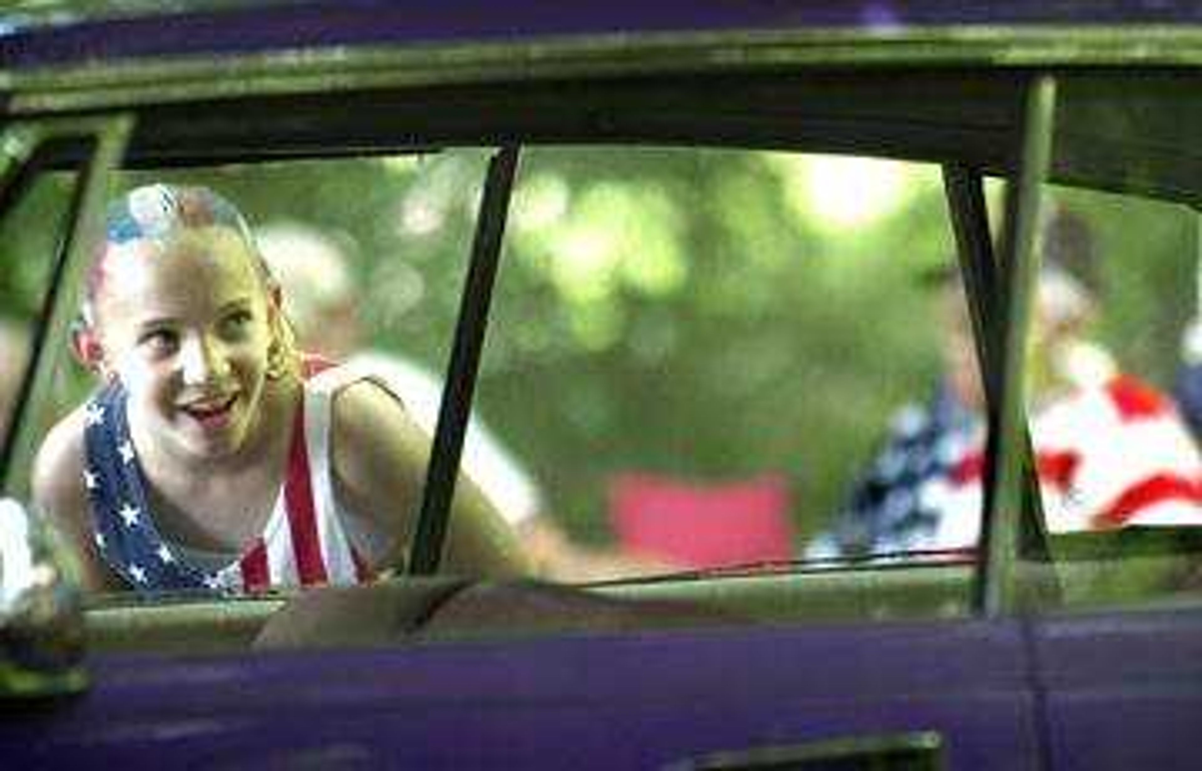 Clad in patriotic colors, Hannah Roach of Jackson admired the insides of one of the displayed cars in the Jackson City Park on July 4th.