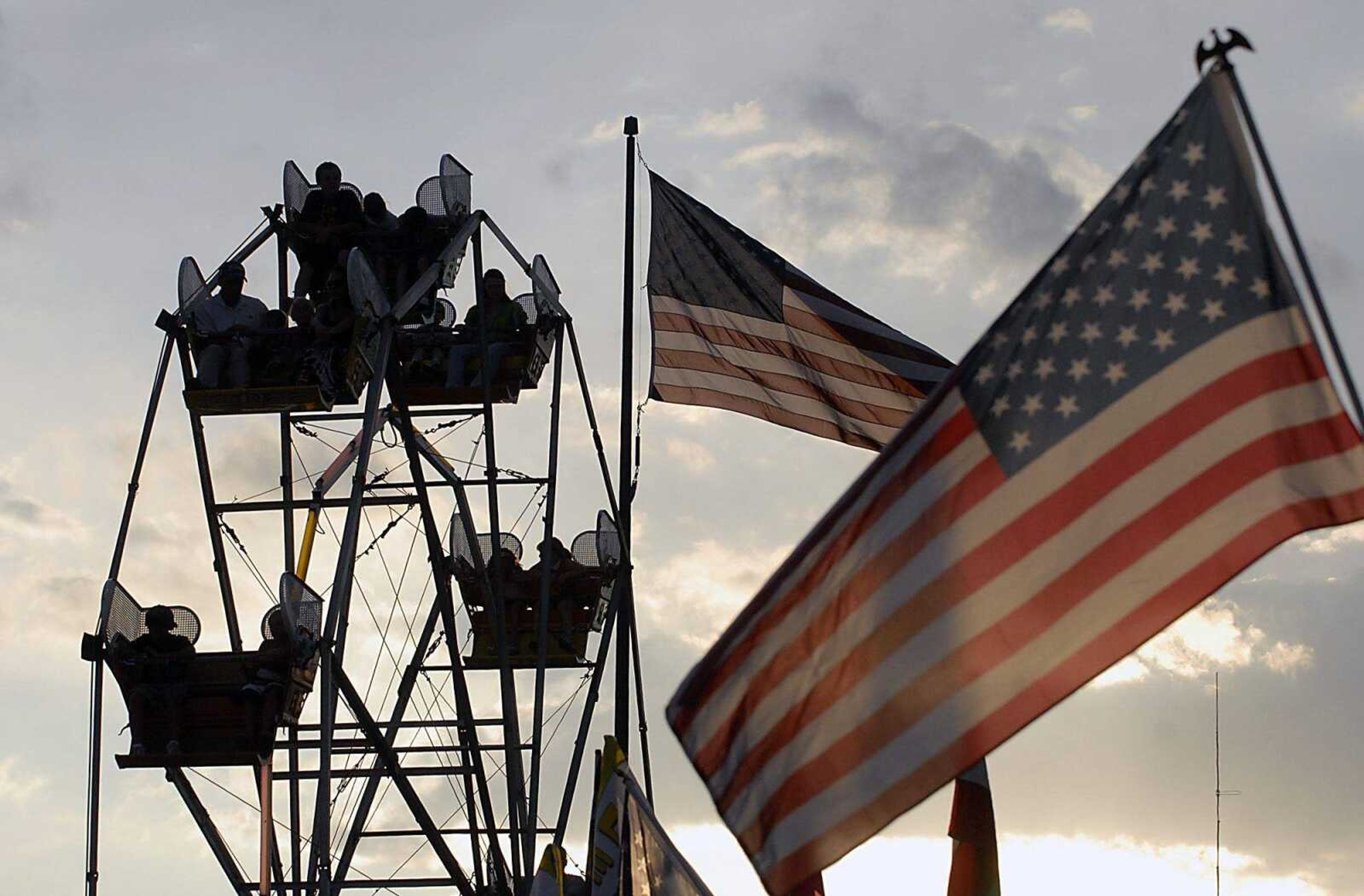 Several American flags near the Ferris wheel Thursday, July 23, 2009, at Homecomers in downtown Jackson. (Kit Doyle)