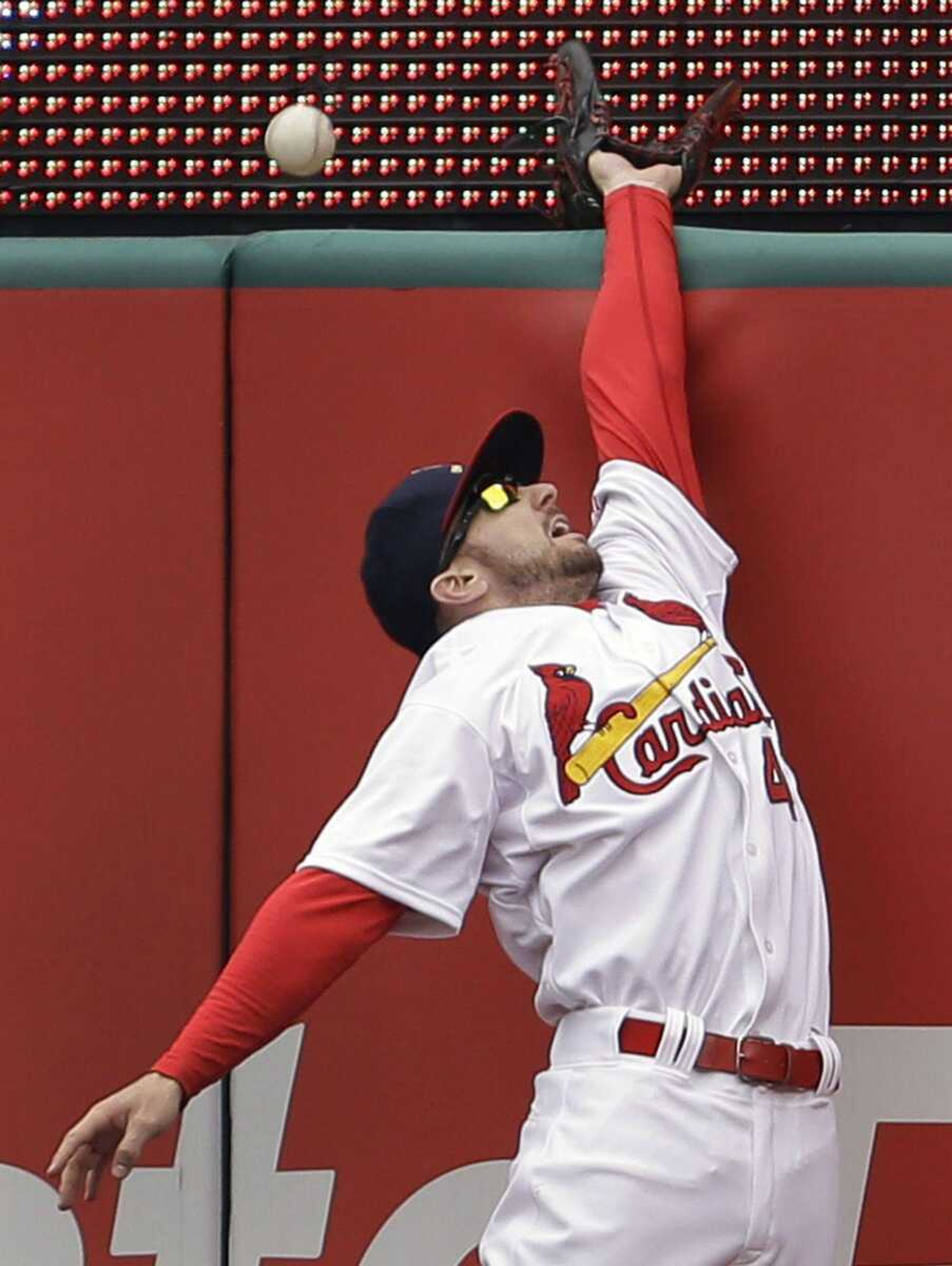 Cardinals right fielder Shane Robinson cannot reach a ball hit for a solo home run by the Pirates&#8217; Garrett Jones during the seventh inning Sunday in St. Louis. (Jeff Roberson ~ Associated Press)