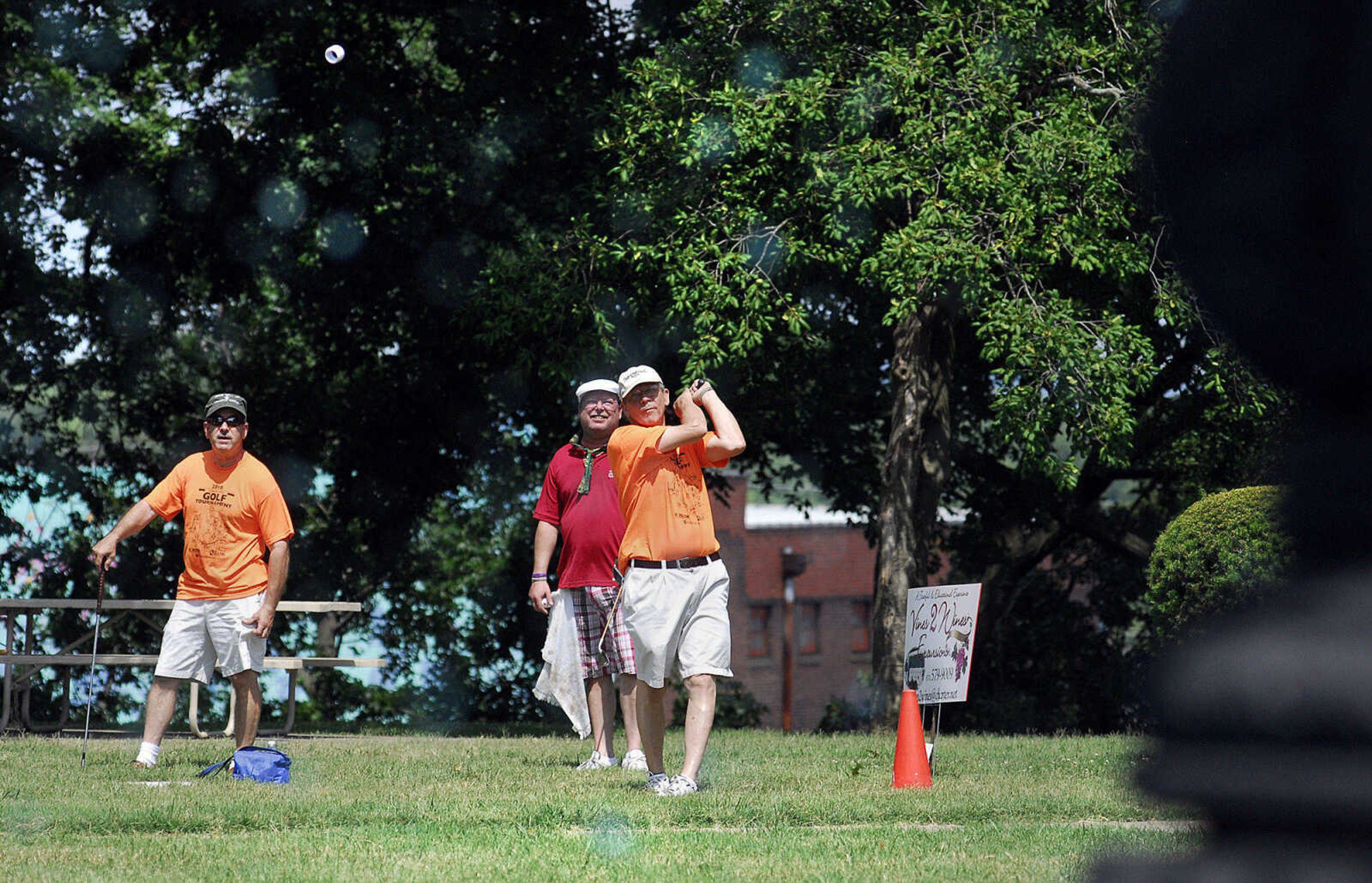 LAURA SIMON~lsimon@semissourian.com
Chuck Rosenkoetter hits his BirdieBall towards the fountain behind the Common Pleas Courthouse in Cape Girardeau Sunday, June 27, 2010 as his teammates Tom Meyer, left, and Todd Roth watch from behind. Rosenkoetter's wife signed him up for the First-Ever Fifth Annual Louis J. Lorimier Memorial Worl Famous Downtown Golf Tournament as an anniversary present.