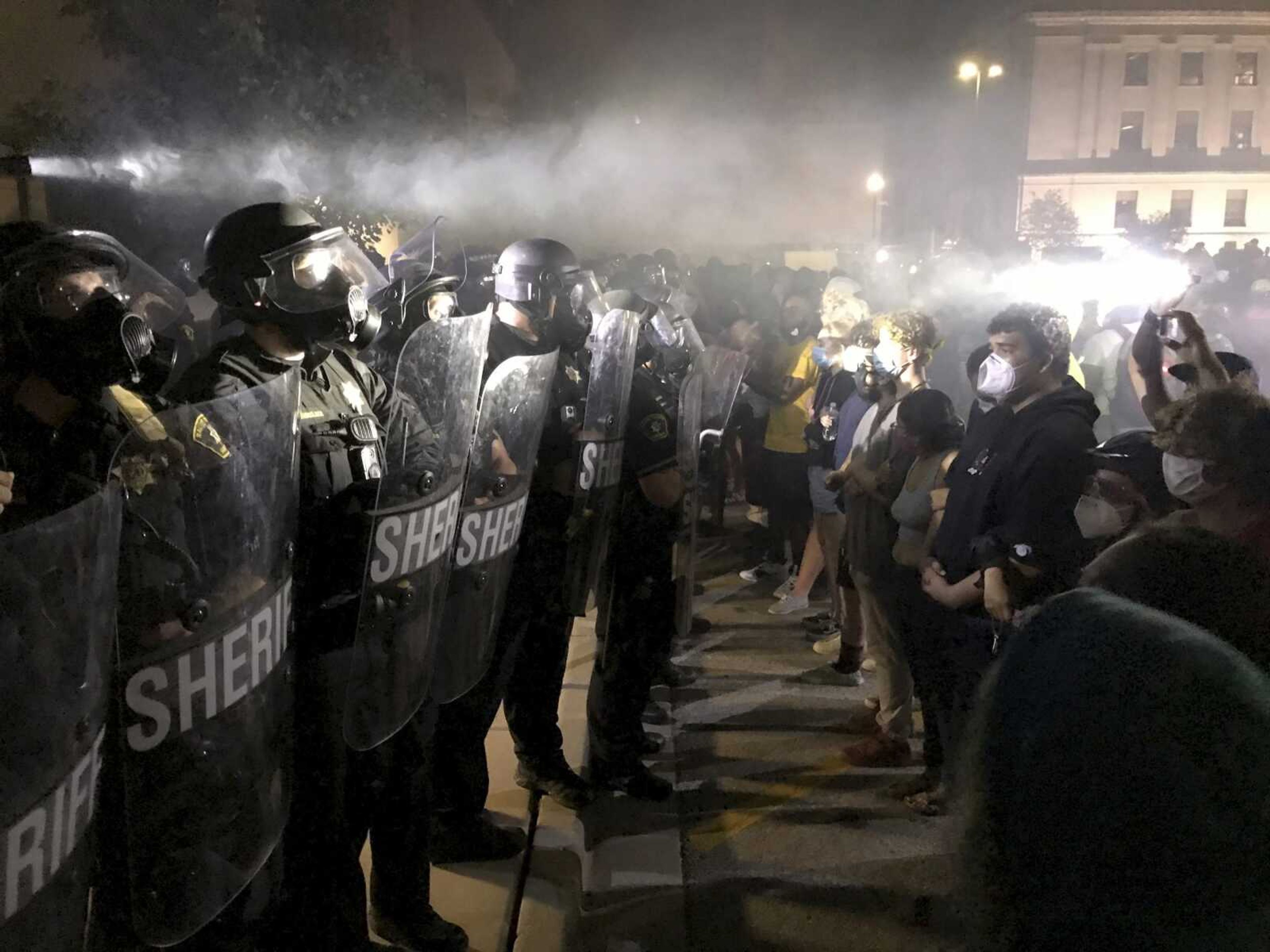 Protestors confront Kenosha County Sheriff's Deputies outside the Kenosha Police Department in Kenosha, Wis., on Sunday, Aug. 23, 2020. Kenosha police shot a man Sunday evening, setting off unrest in the city after a video appeared to show the officer firing several shots at close range into the man's back. (Mike De Sisti/Milwaukee Journal-Sentinel via AP)