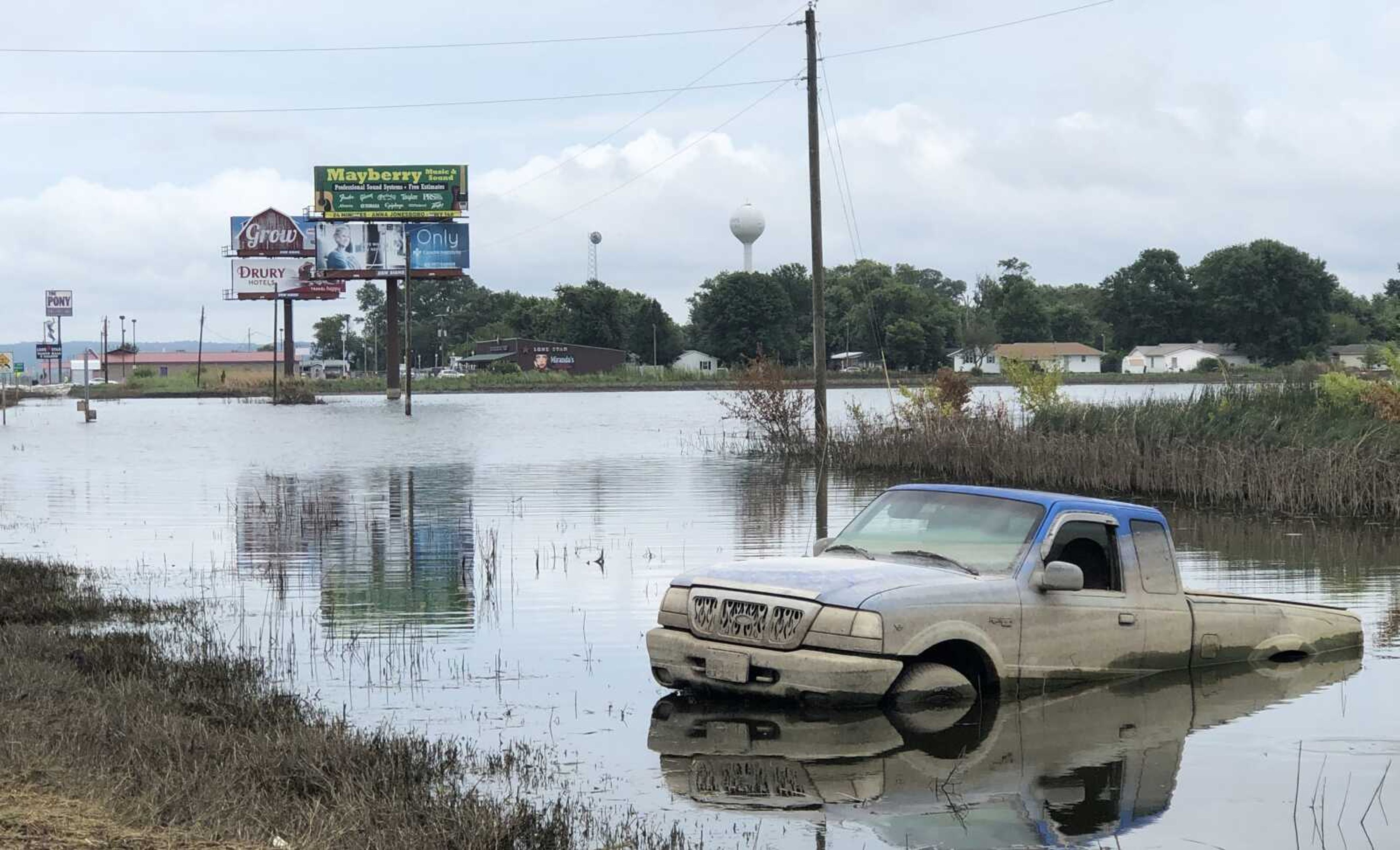 A truck stuck in a ditch along Illinois Route 146 is seen Monday, July 29, 2019, near East Cape Girardeau, Illinois.