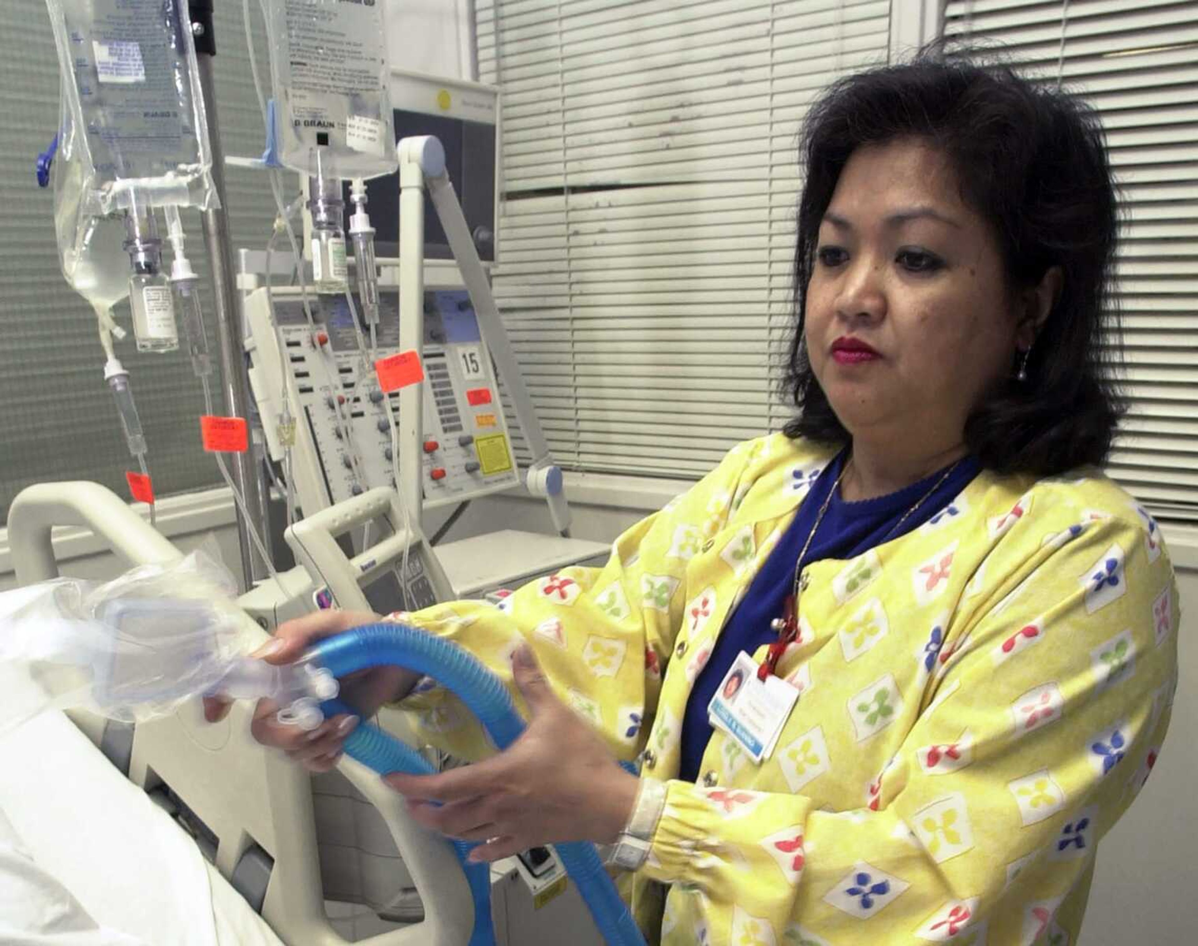 Lovely R. Suanino, a respiratory therapist at Newark Beth Israel Medical Center in Newark, New Jersey, demonstrates setting up a ventilator in the intensive care unit of the hospital in 2005. U.S. hospitals bracing for a possible onslaught of coronavirus patients with pneumonia and other breathing difficulties could face a critical shortage of mechanical ventilators and health care workers to operate them.