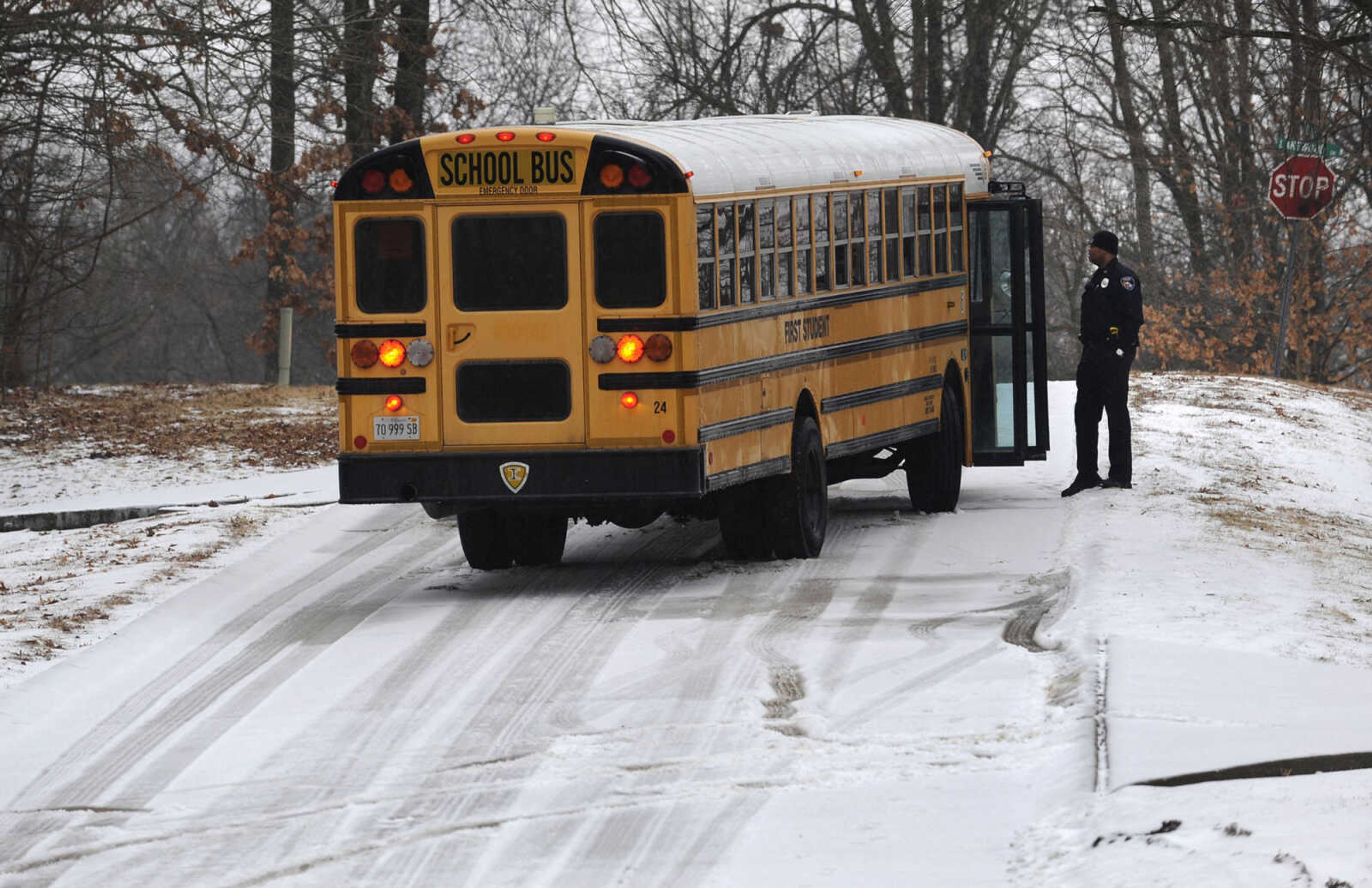 FRED LYNCH ~ flynch@semissourian.com
A First Student school bus waits for assistance Tuesday afternoon, Feb. 4, 2014, after it became stuck on El Rio Drive, a hill section approaching Lakewood Drive, in north Cape Girardeau. Students had been released from school early due to weather.