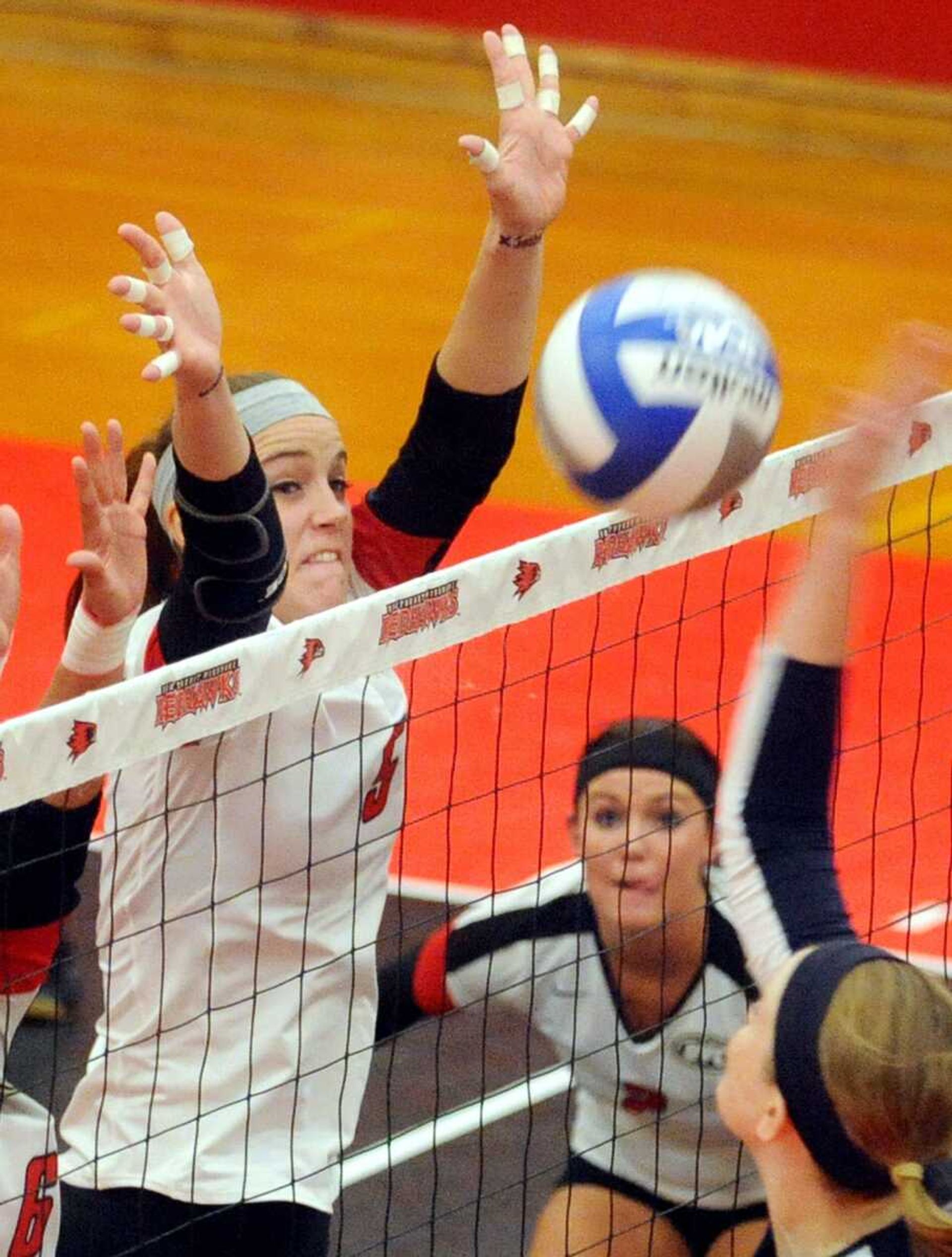 Southeast Missouri State's Emily Coon blocks a shot from Tennessee-Martin hitter Emily Keaton during the first game of the Redhawks match against the Skyhawks on Tuesday at Houck Field House.LAURA SIMONlsimon@semissourian.com